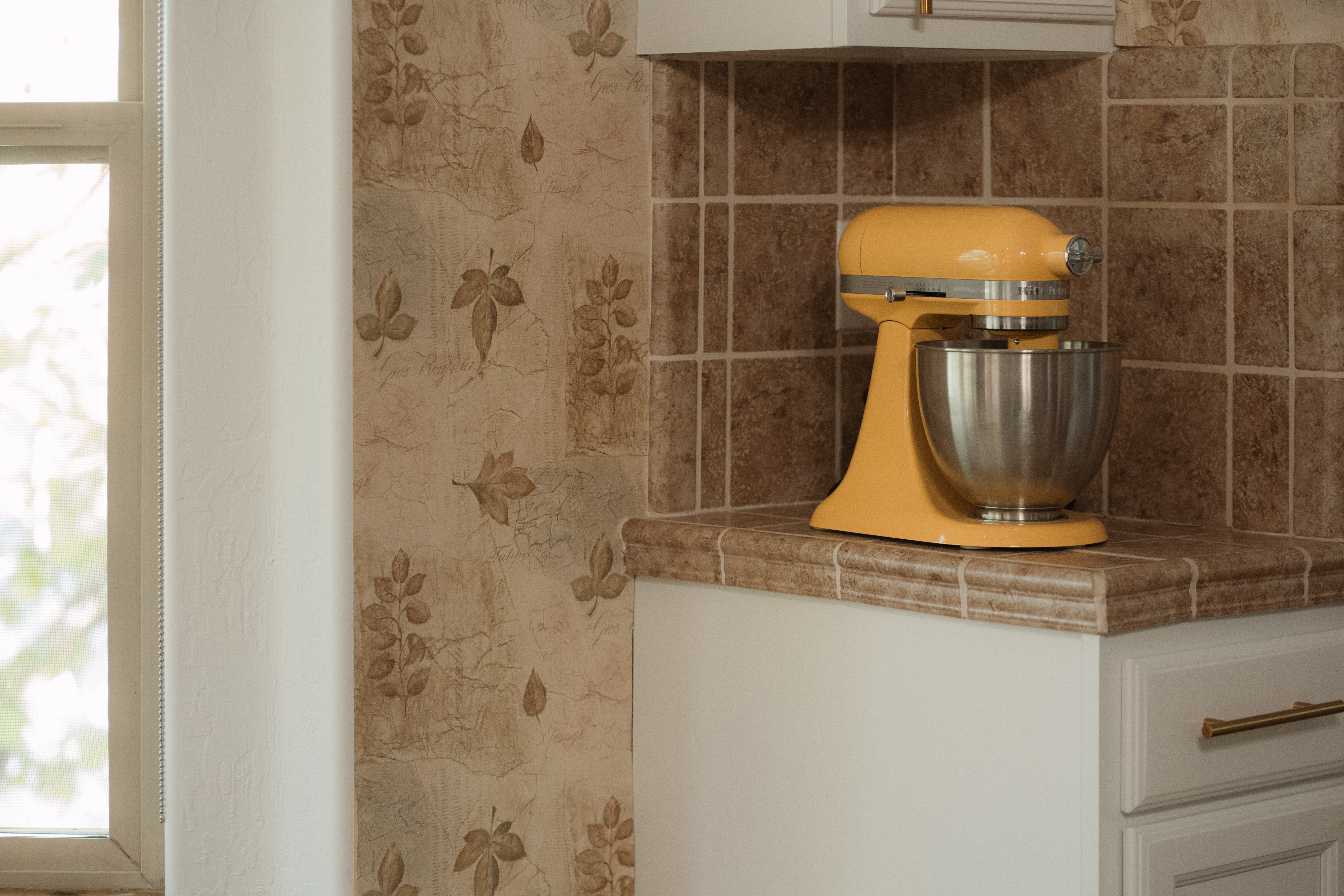 Charming kitchen nook with sunny stand mixer and warm natural light