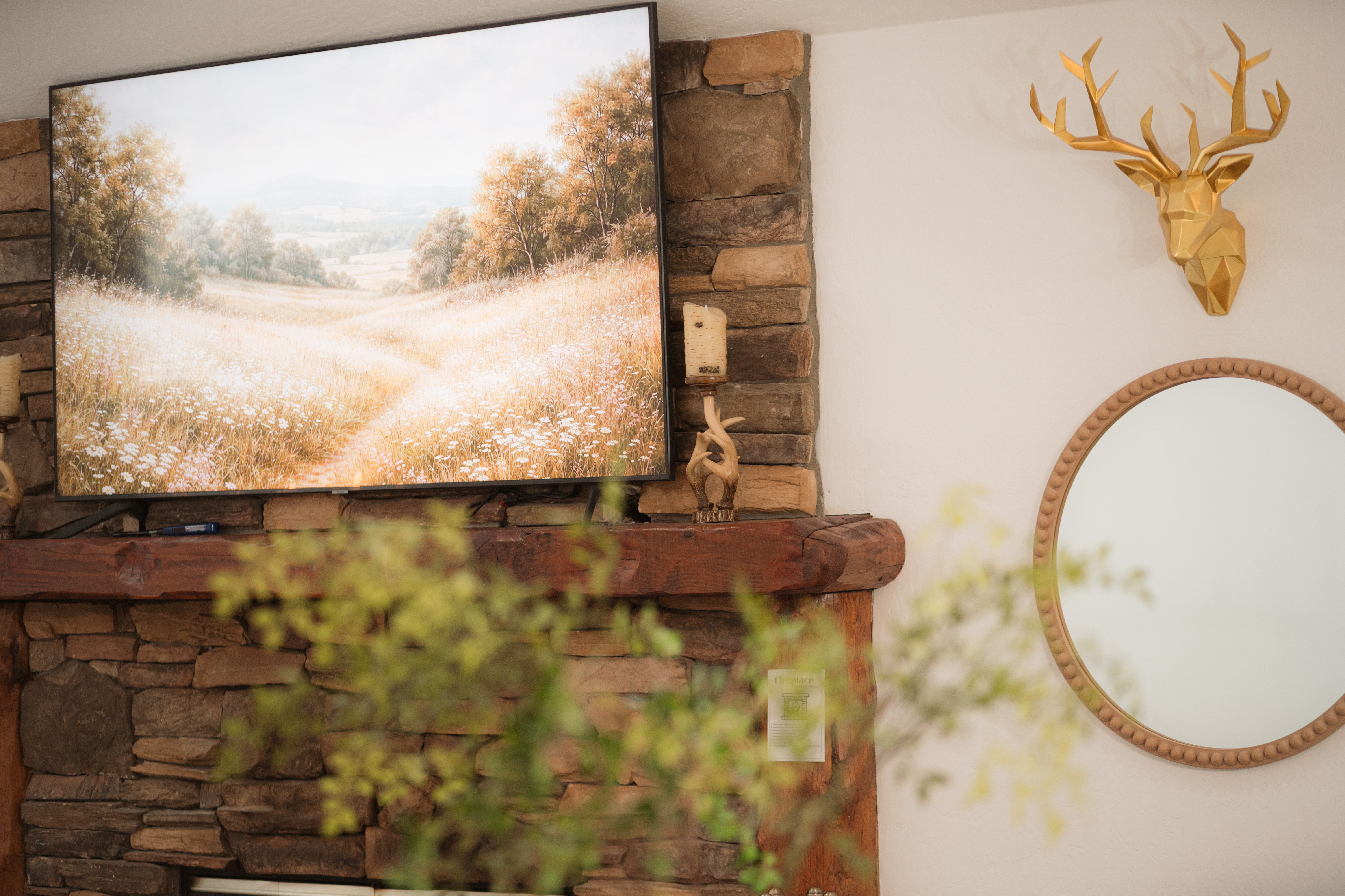 Cozy stone fireplace with rustic mantel and elegant cabin-style decor