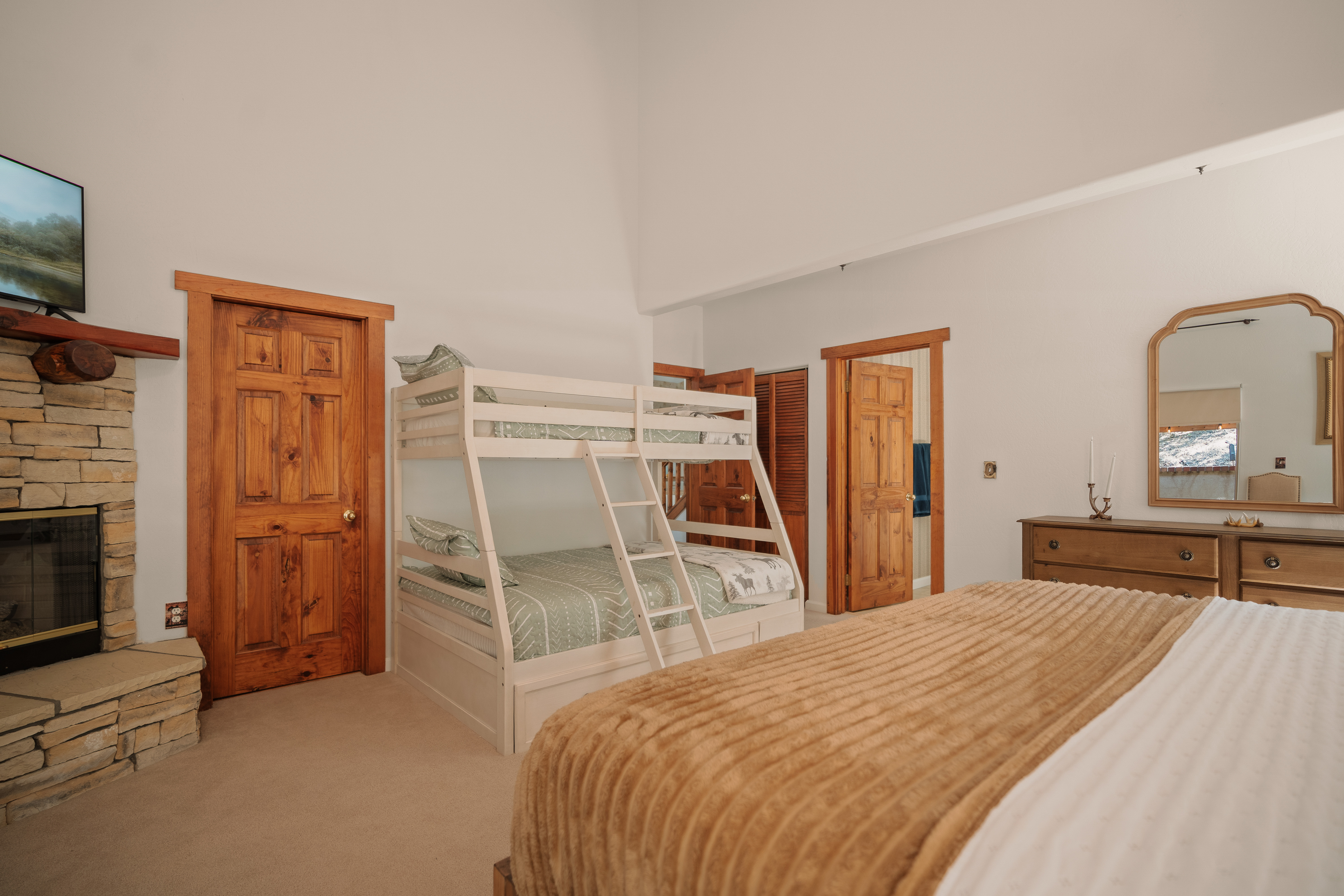 Spacious lodge-style bedroom with fireplace and family-friendly bunk beds