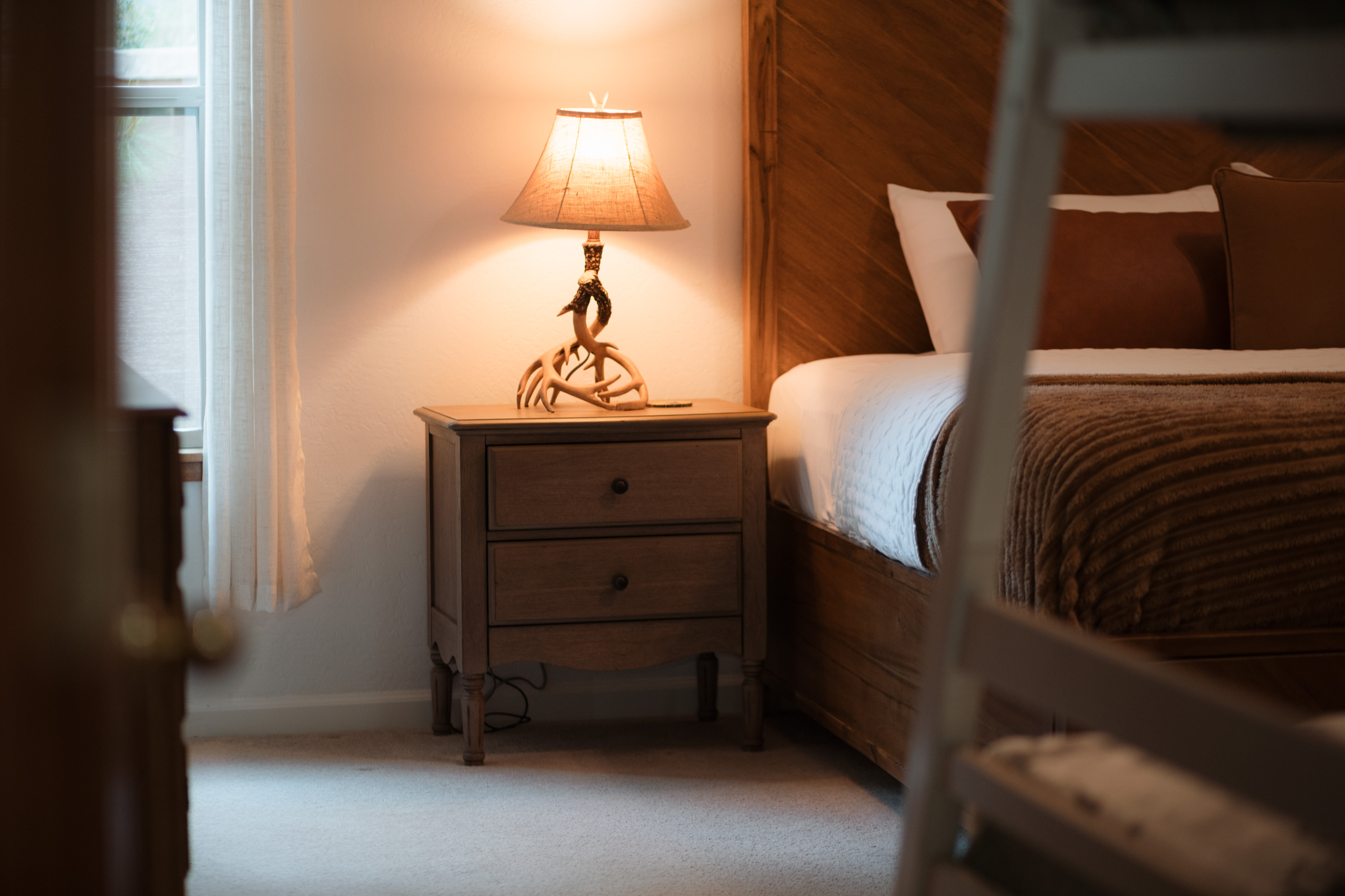 Warm, cozy bedroom with rustic wood accents and soft ambient light