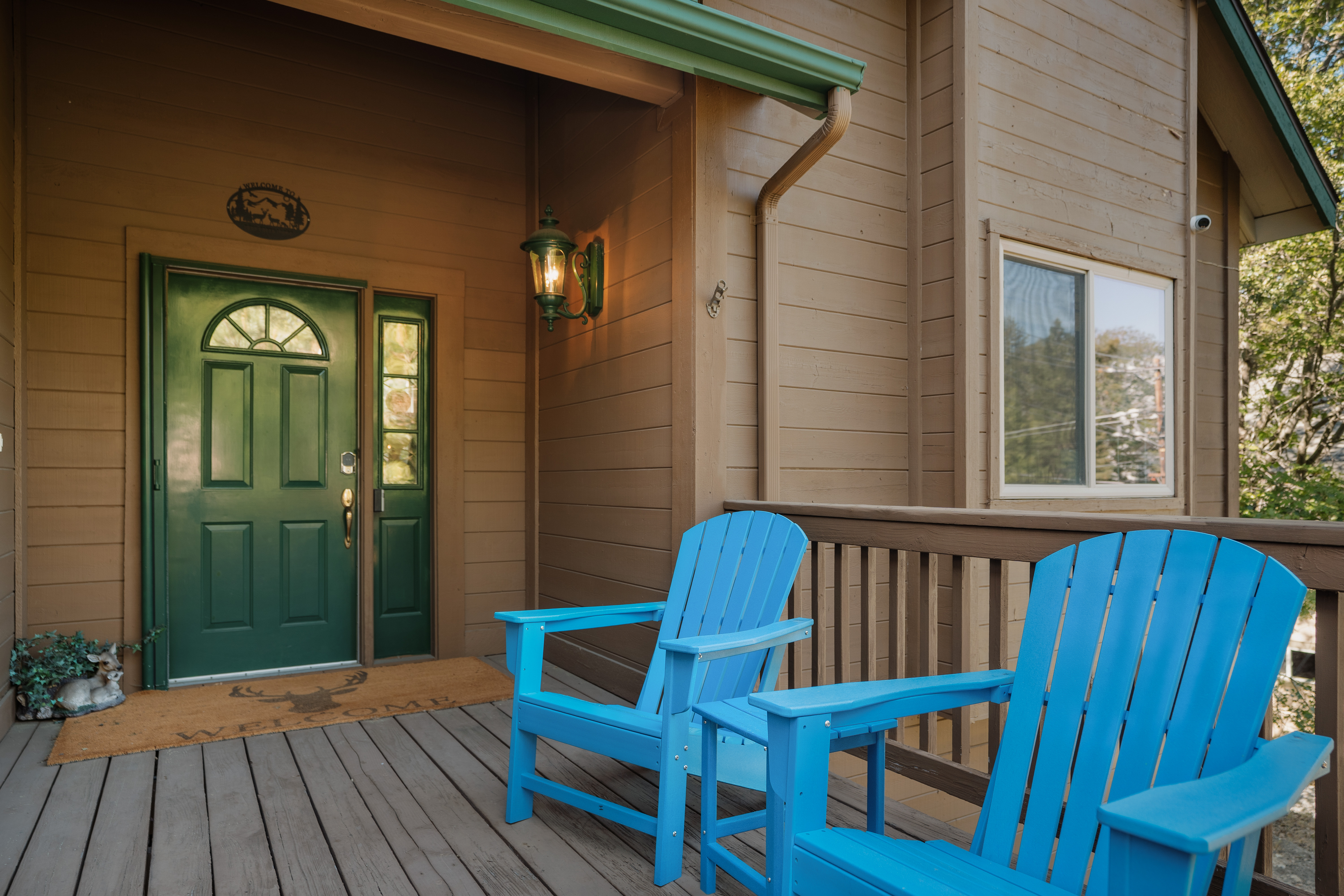 Welcoming porch with blue Adirondack chairs and cozy cabin charm