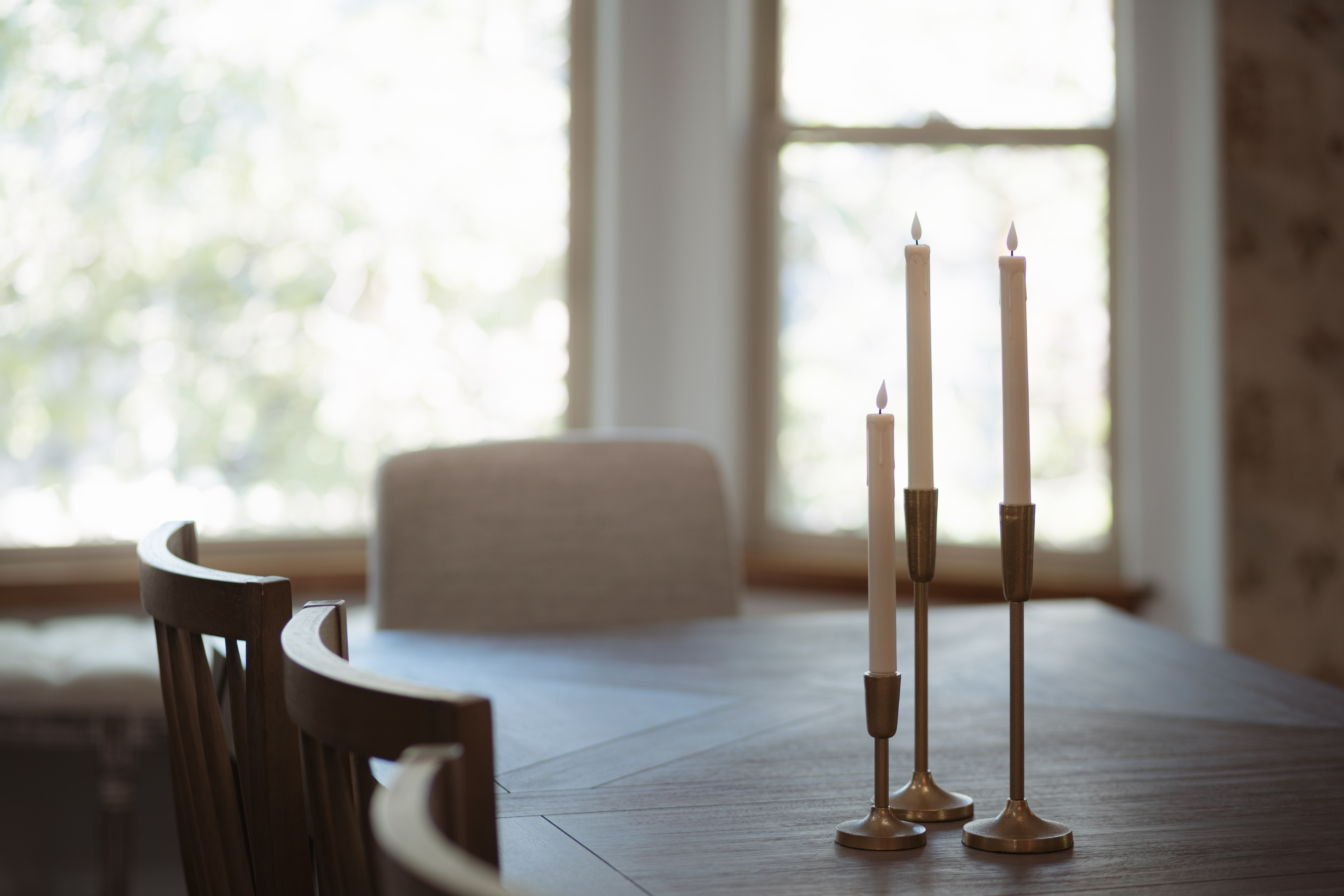 Warm, sunlit dining nook with elegant candlelit charm