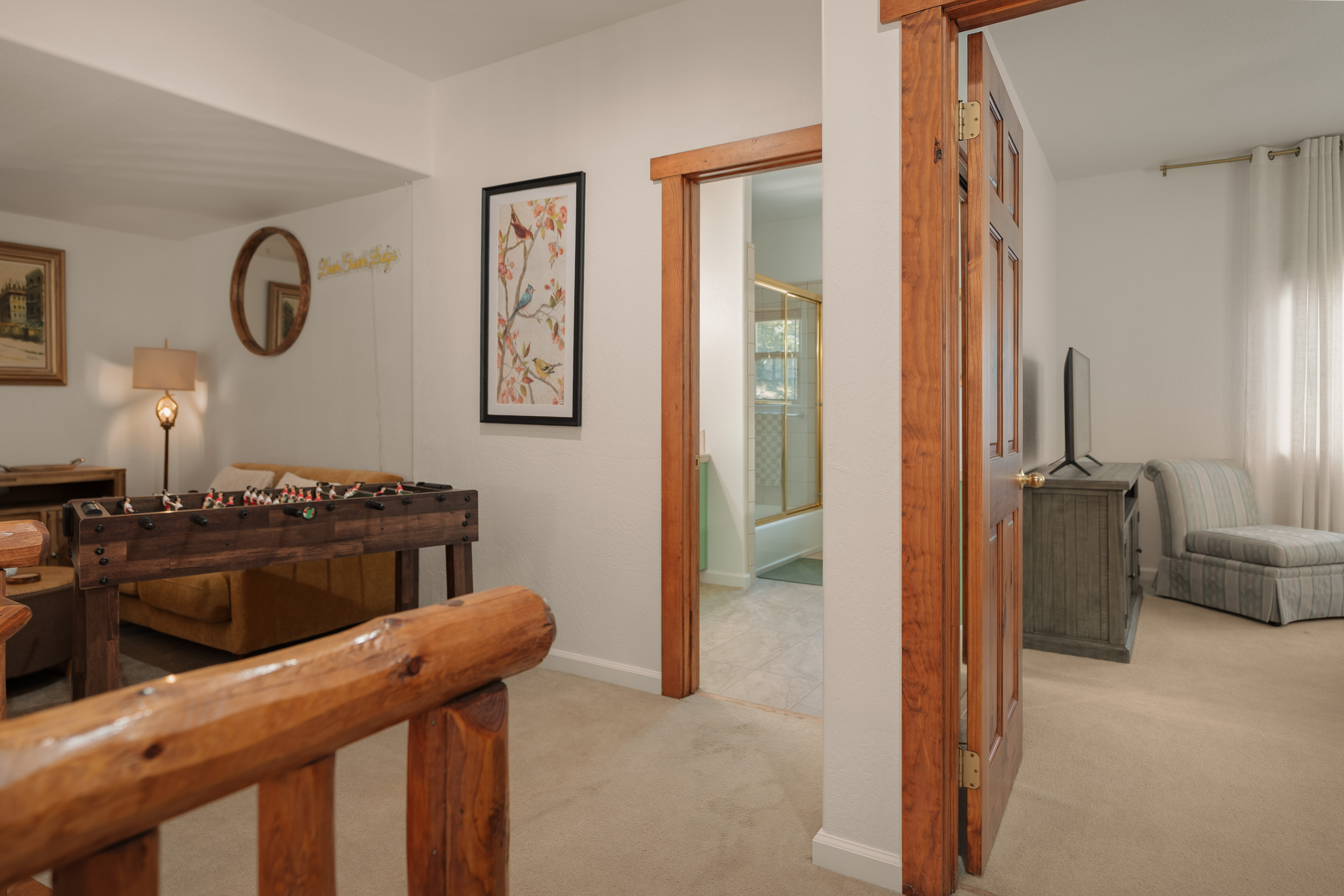 Cozy upstairs lounge with foosball, TV, and bright relaxing spaces