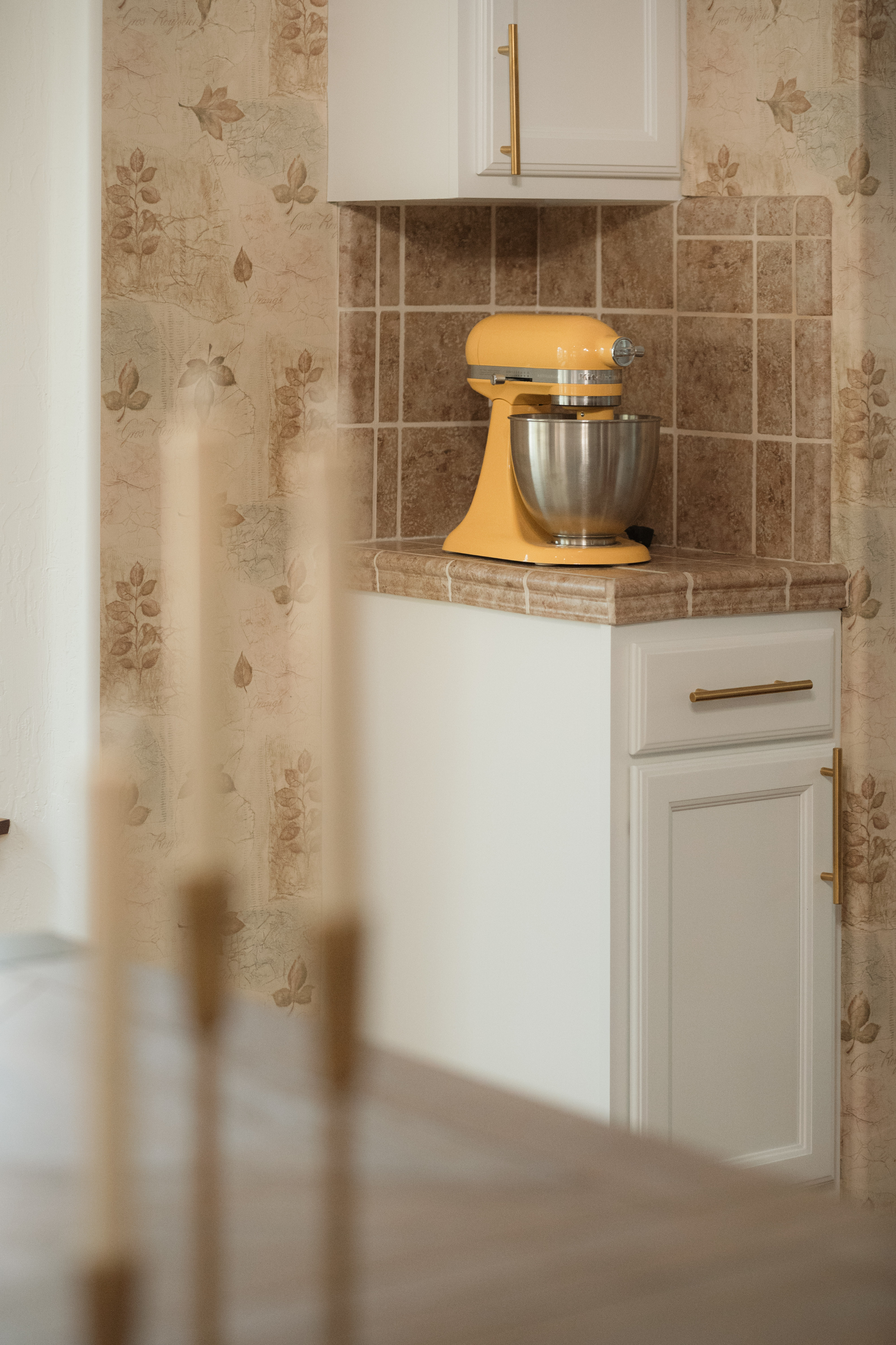 Charming kitchen nook with stylish tile, brass accents, and a cozy feel