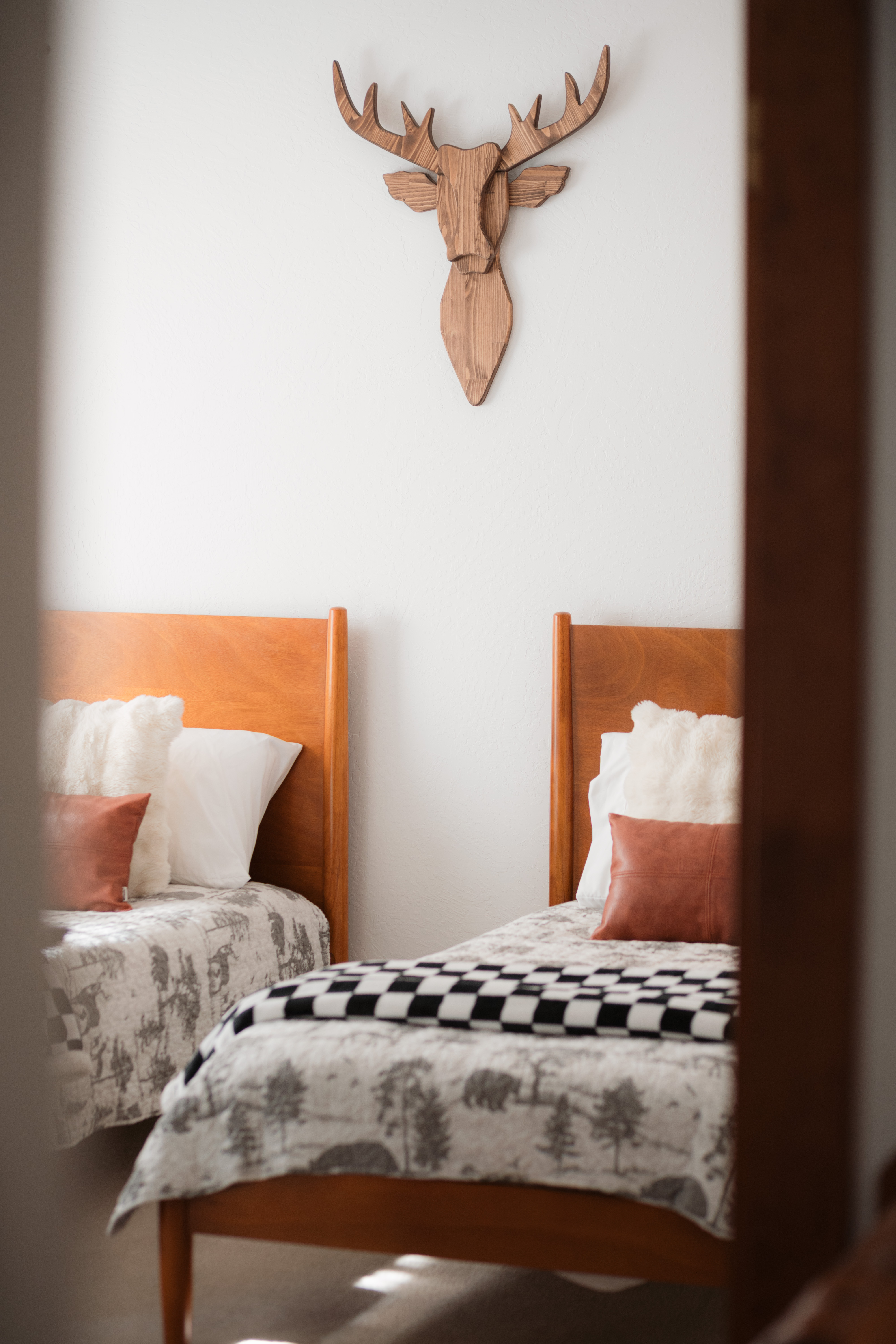 Cozy twin room with rustic wood accents and charming cabin-style decor