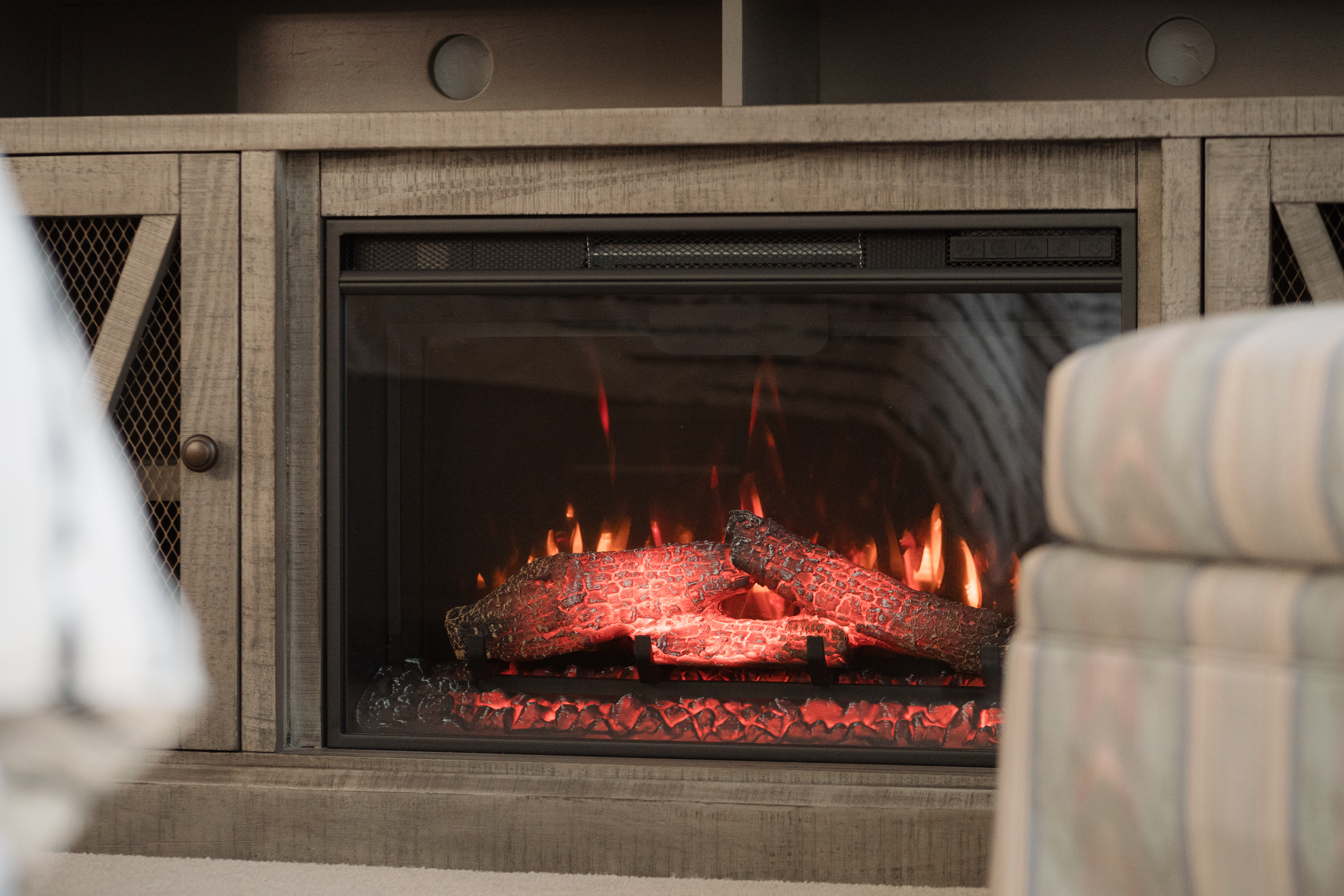 Cozy built-in fireplace with warm glow and stylish wood surround