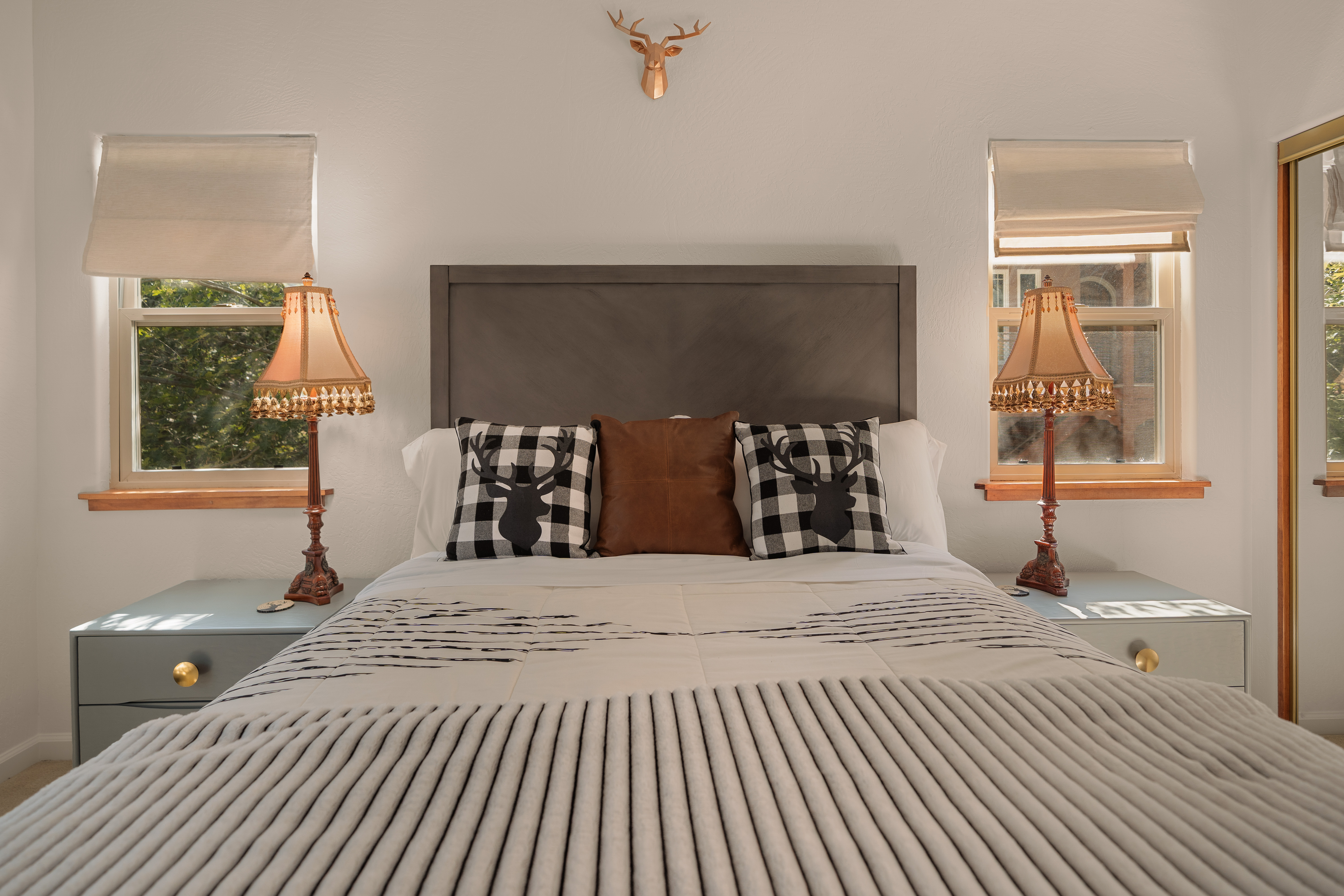 Cozy, sunlit bedroom with rustic charm and balanced styling