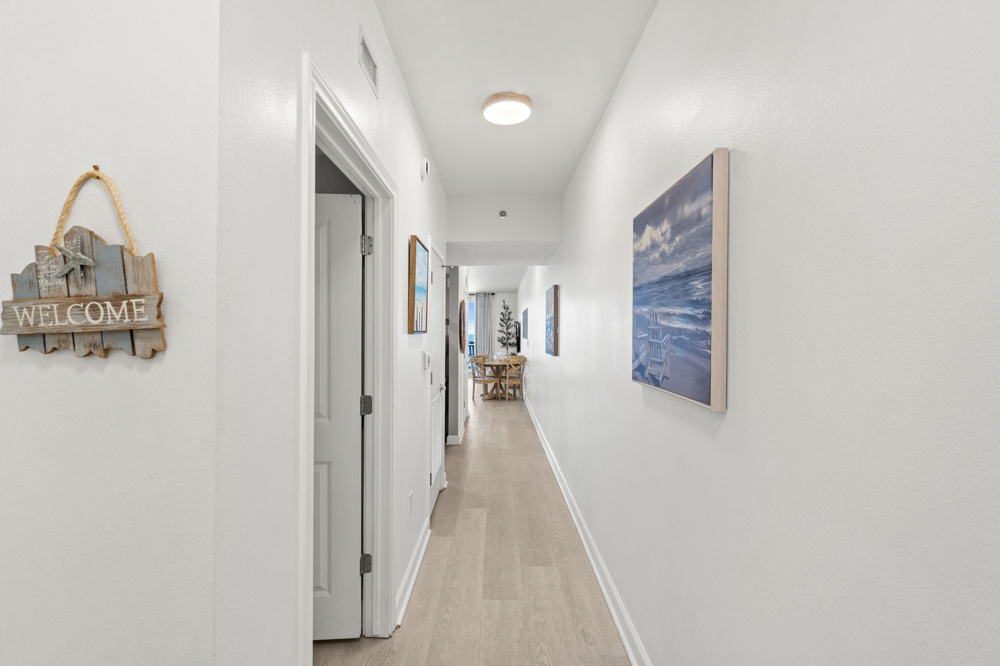 Bright coastal hallway with airy entry and modern finishes