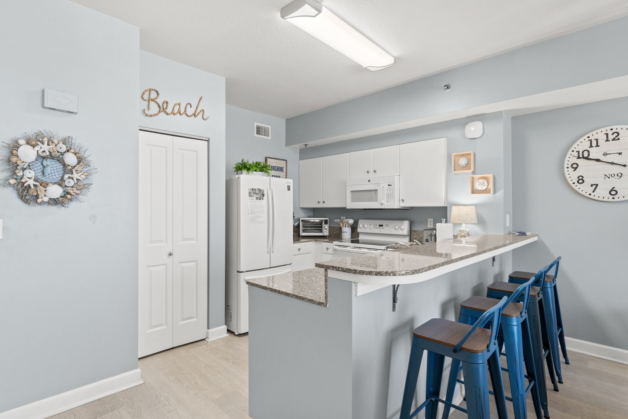 Bright coastal kitchen with breakfast bar seating