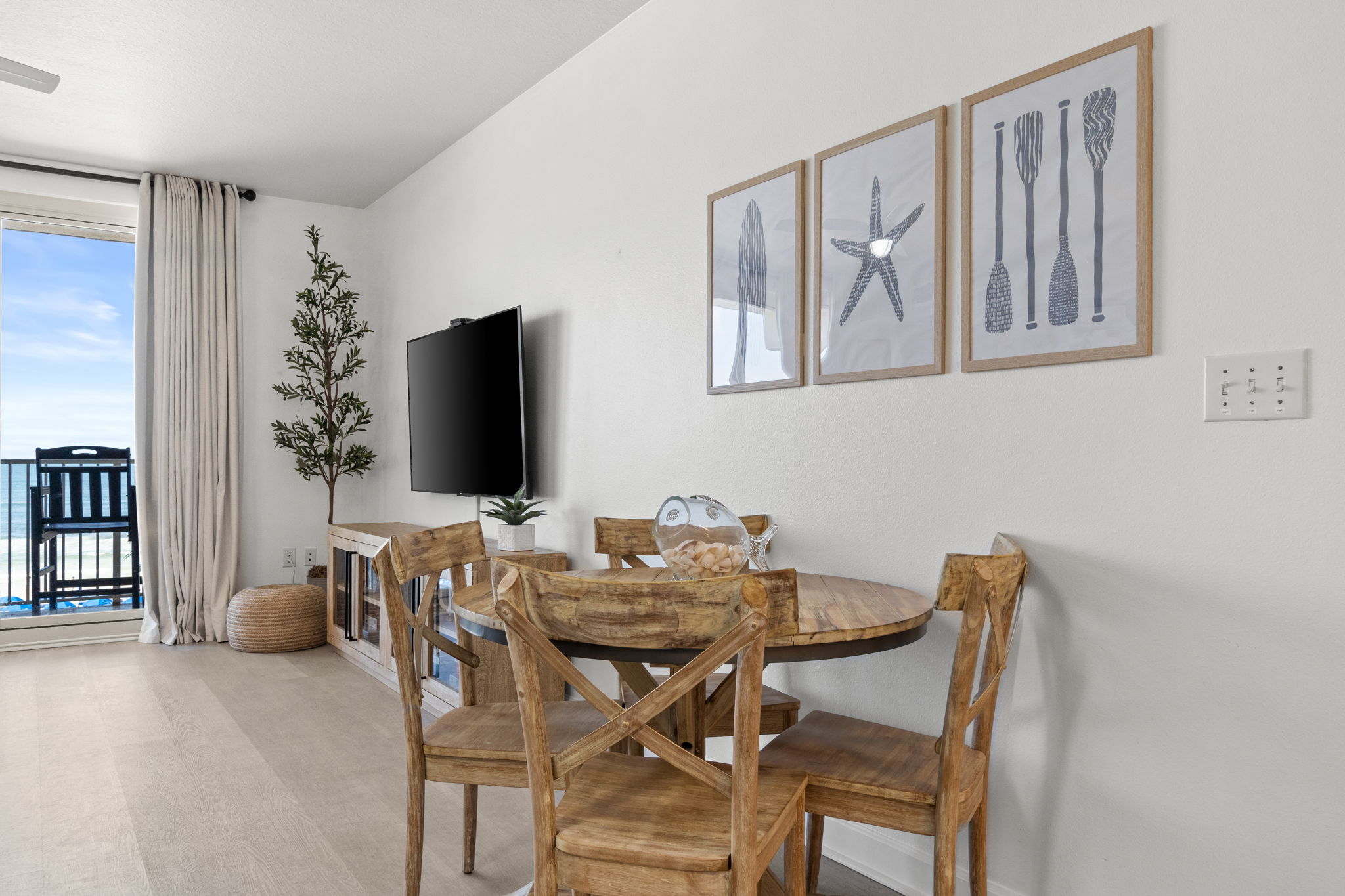 Coastal dining nook with ocean-view balcony and natural light