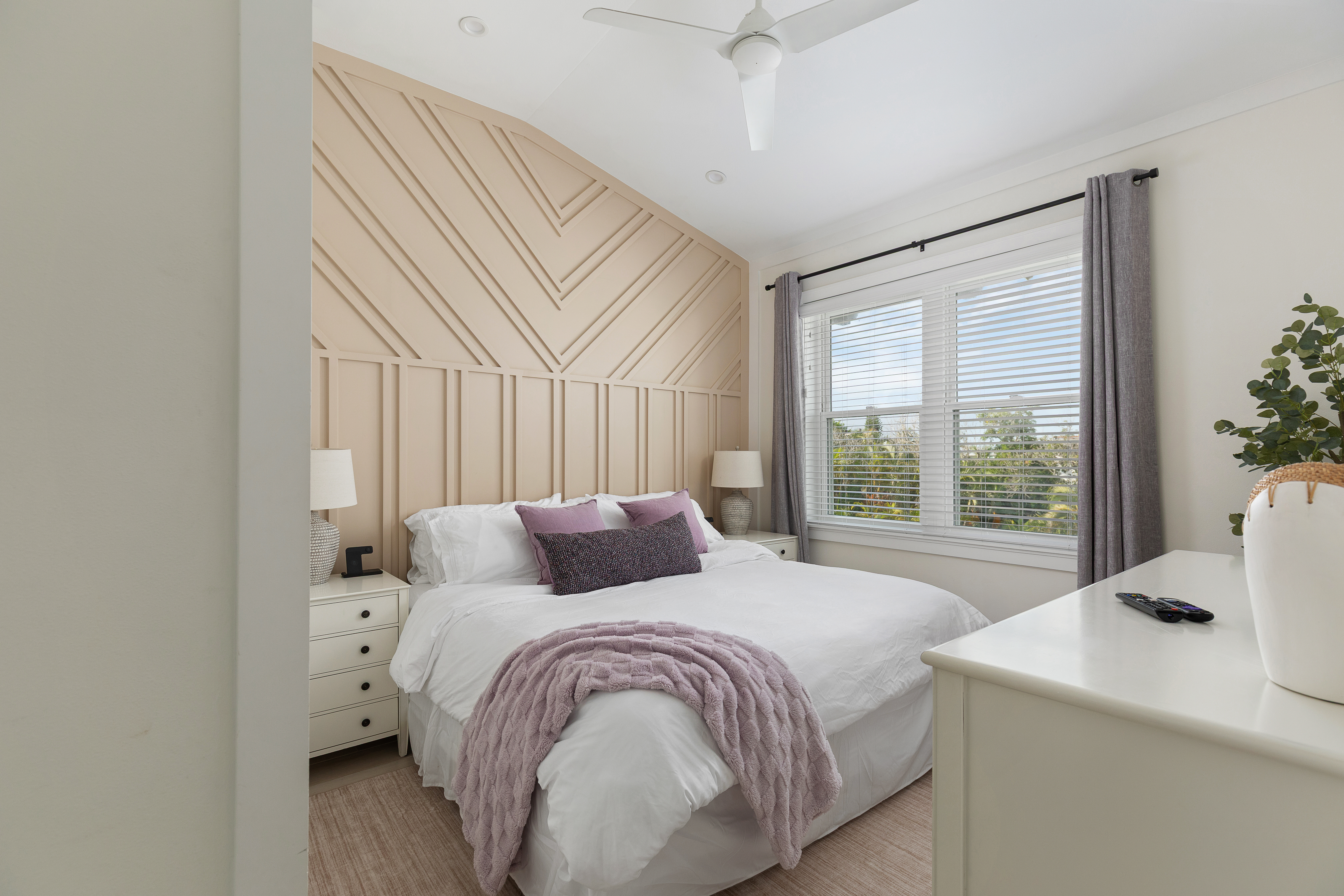 Guest bedroom with Roku TV and bedside charging stations