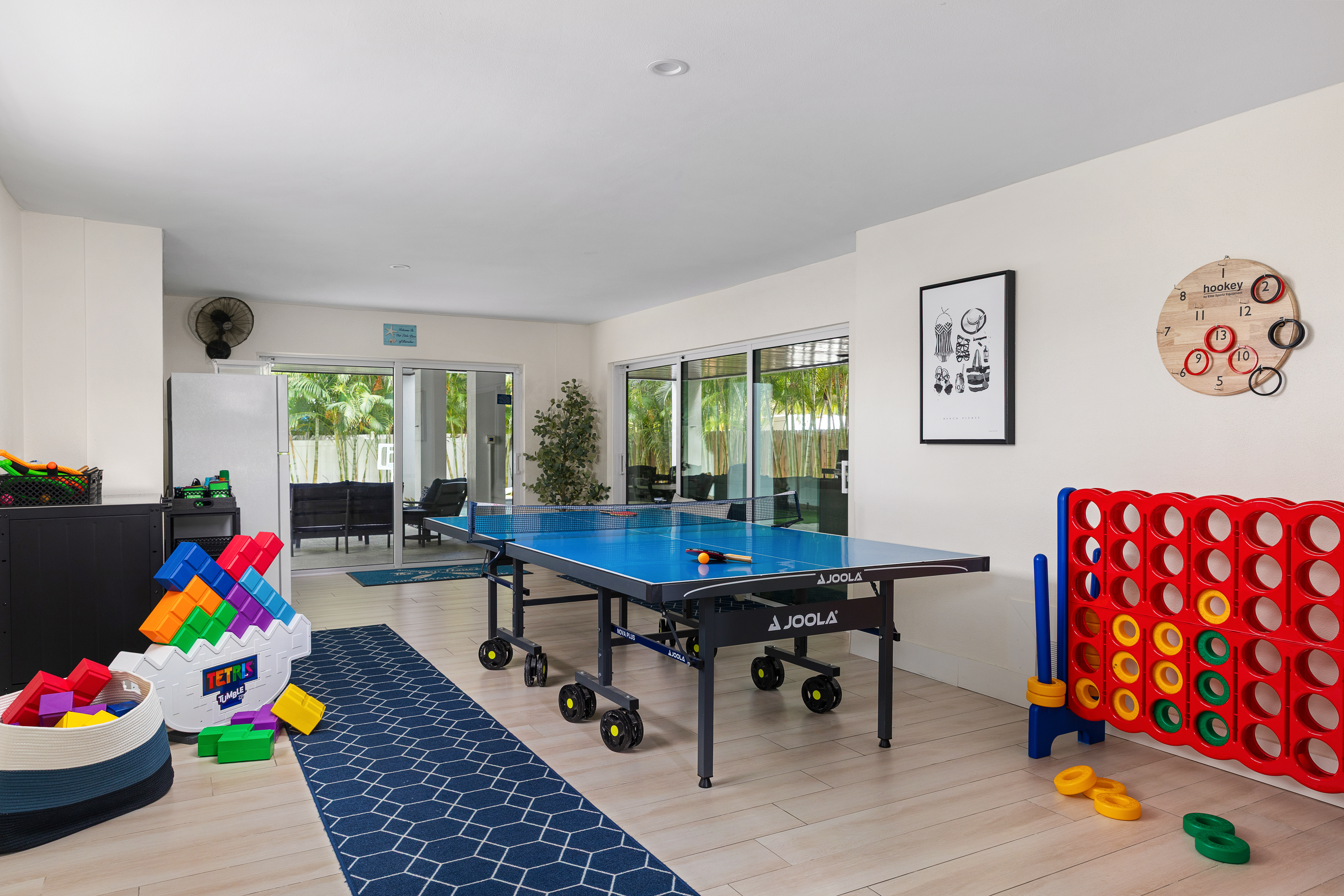Lower-level game room with JOOLA ping pong, oversized Connect Four and a giant block stack