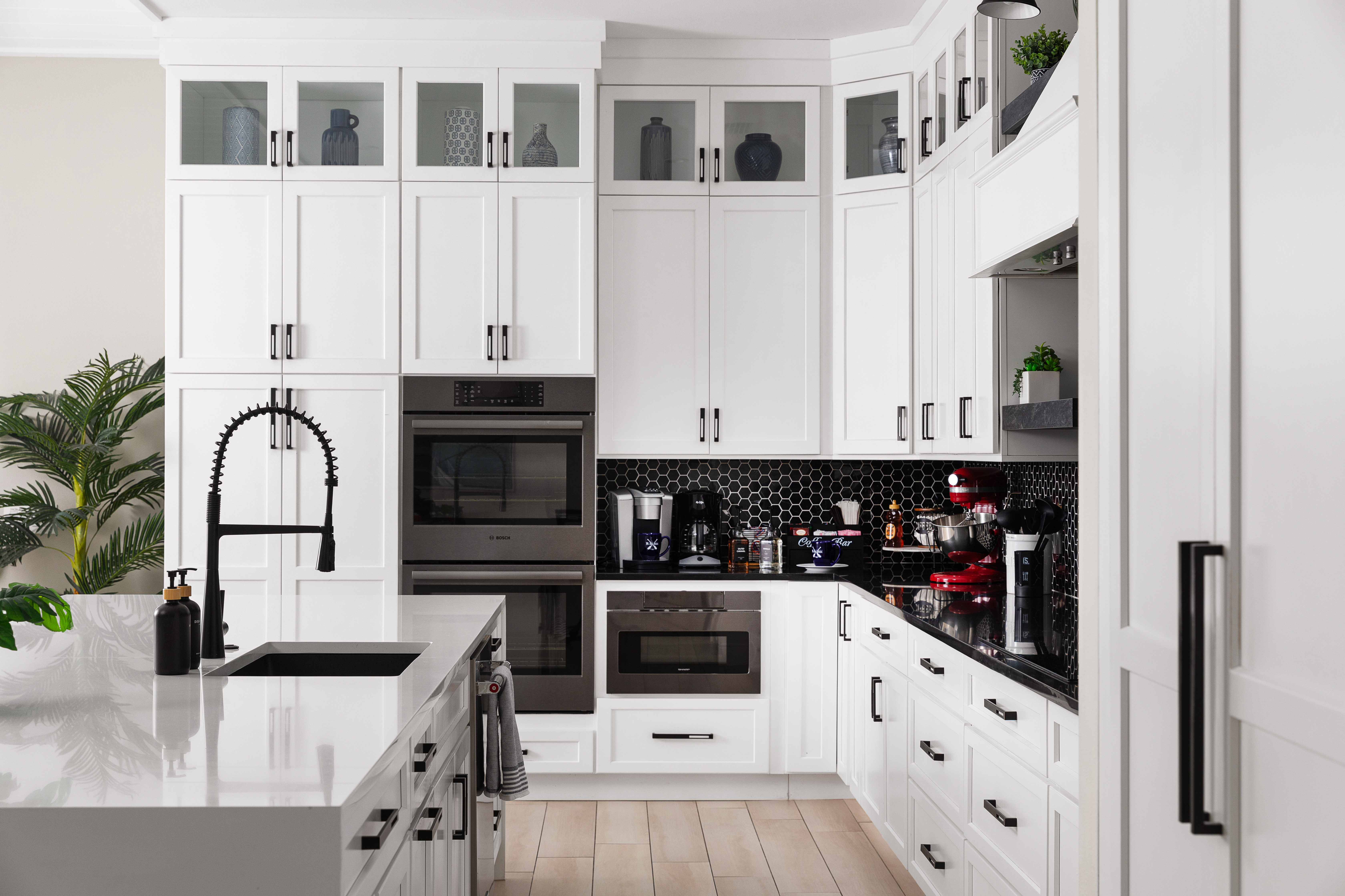 Bosch double ovens, microwave and paneled refrigerator in the main kitchen