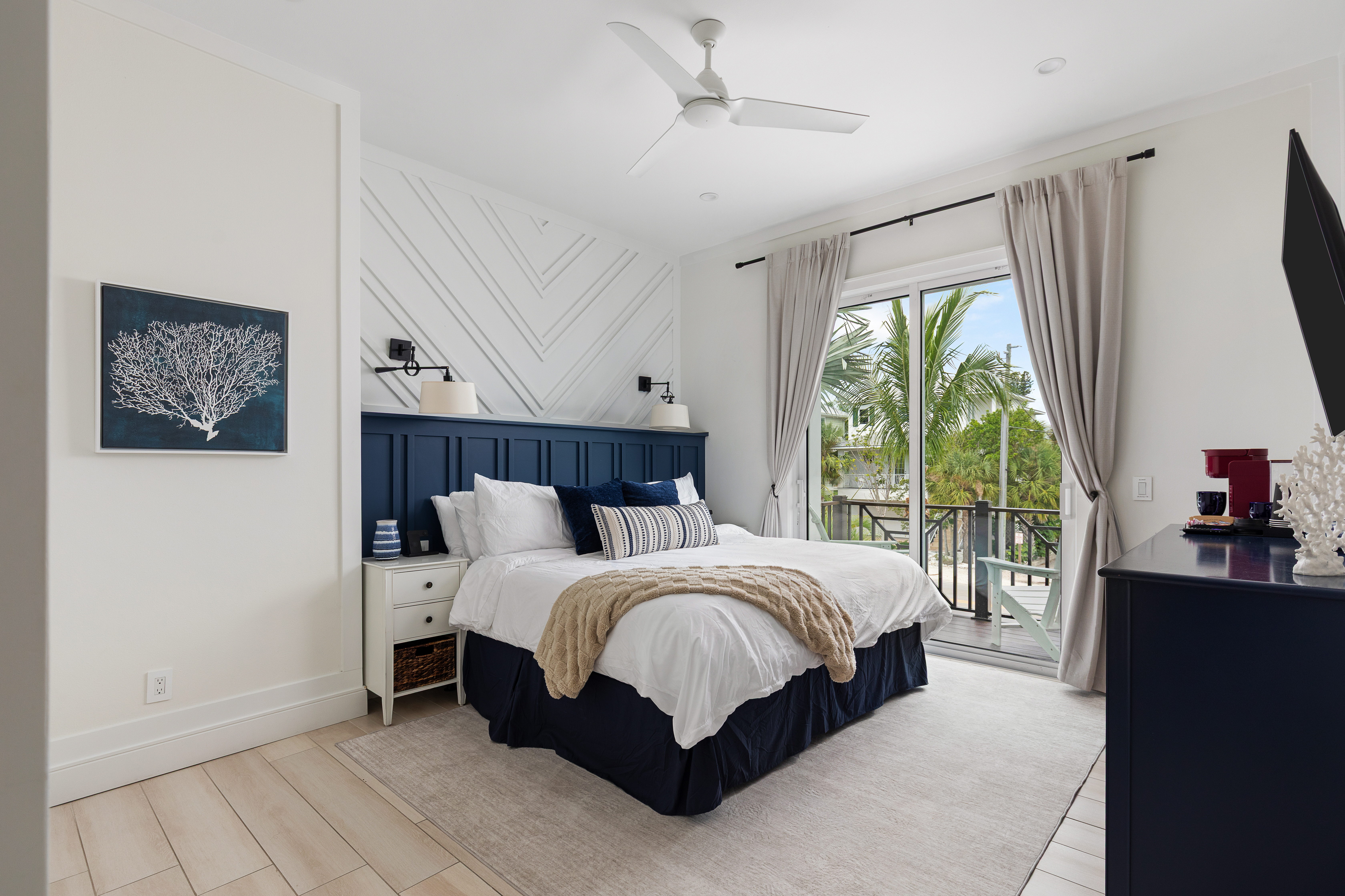 Primary king suite with balcony access and hotel-grade linens