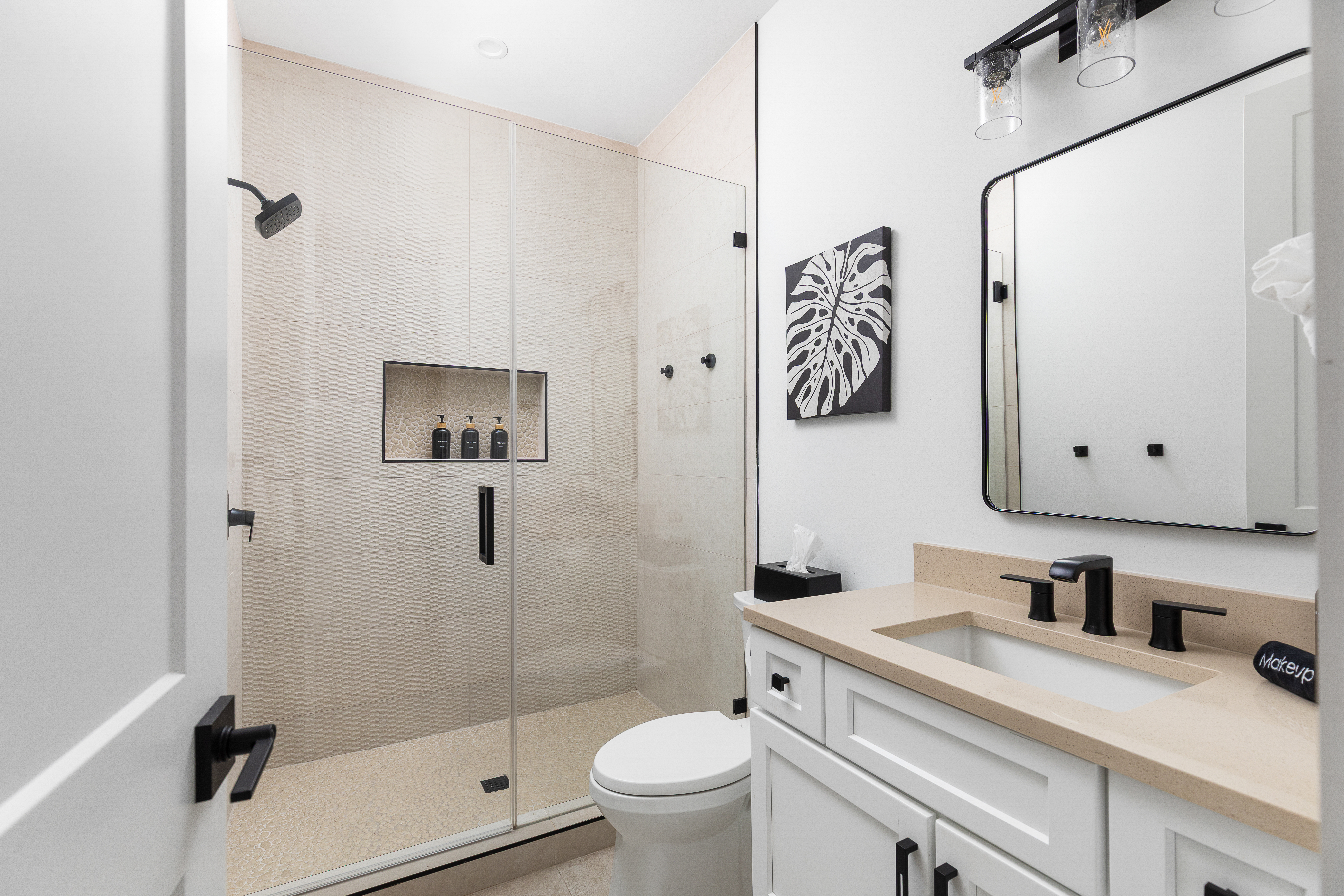 Modern bath with premium fixtures and full guest amenities