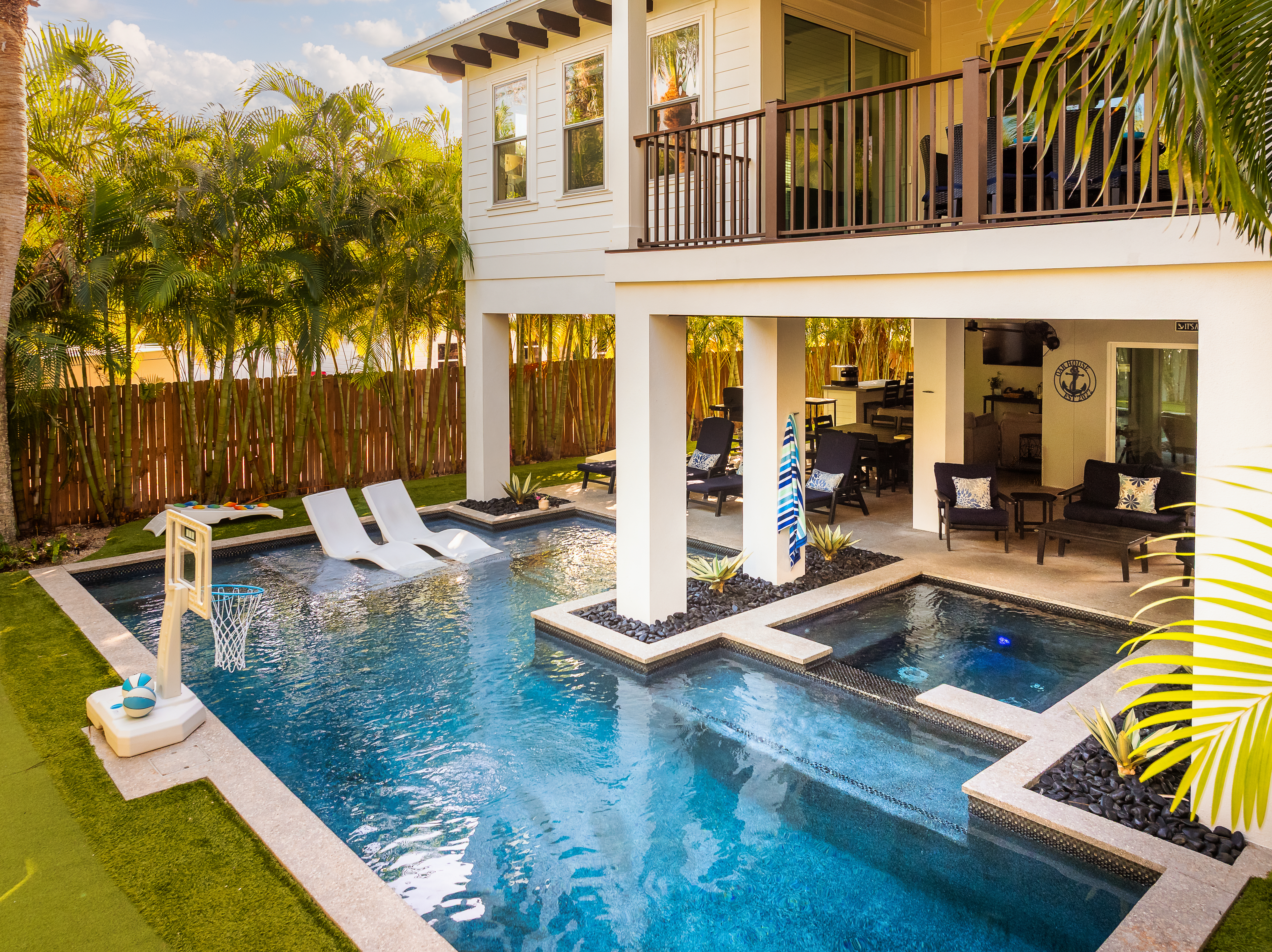 Private heated pool and spa with shaded lounge seating and tropical privacy landscaping