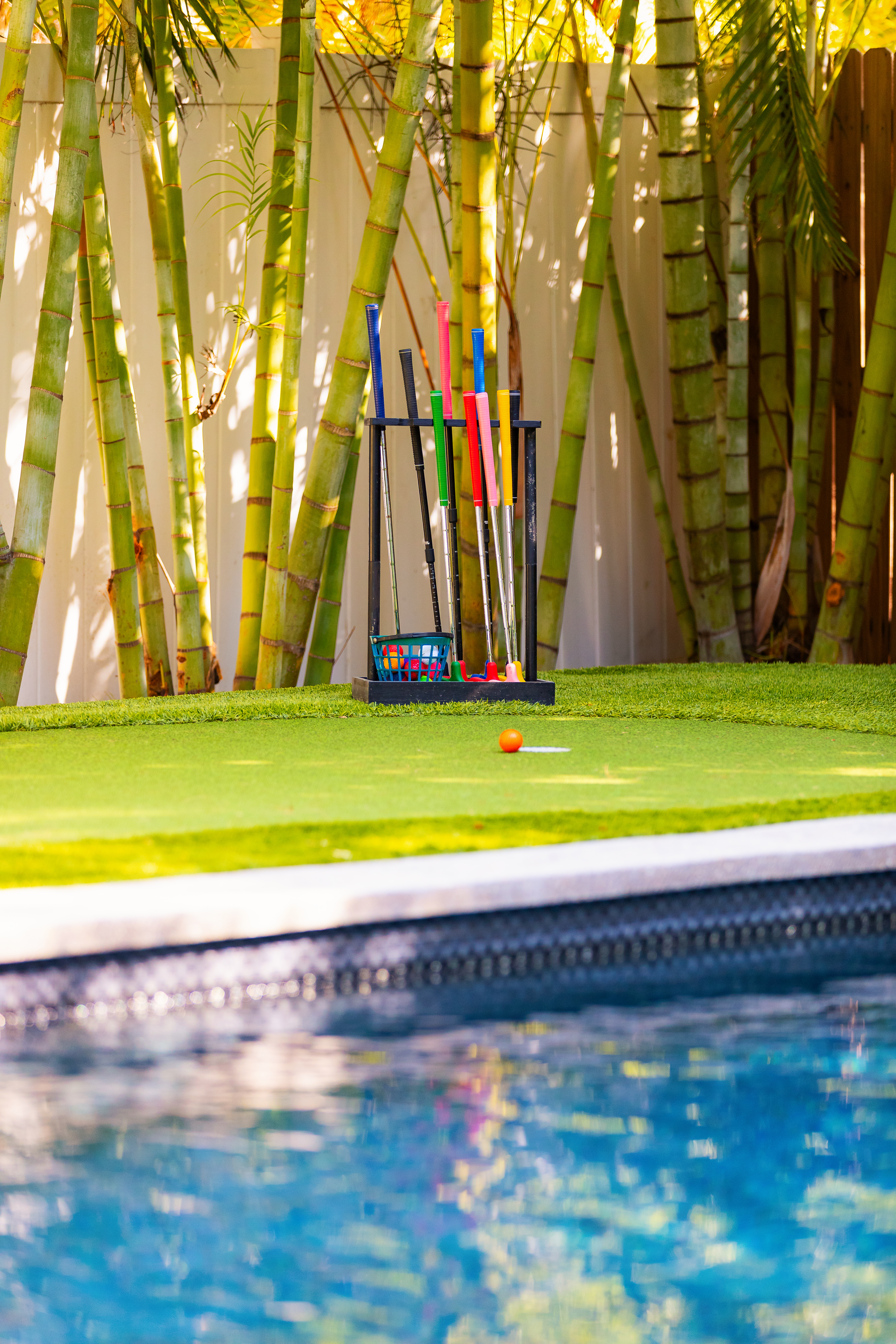 Poolside putting green with putters and balls provided