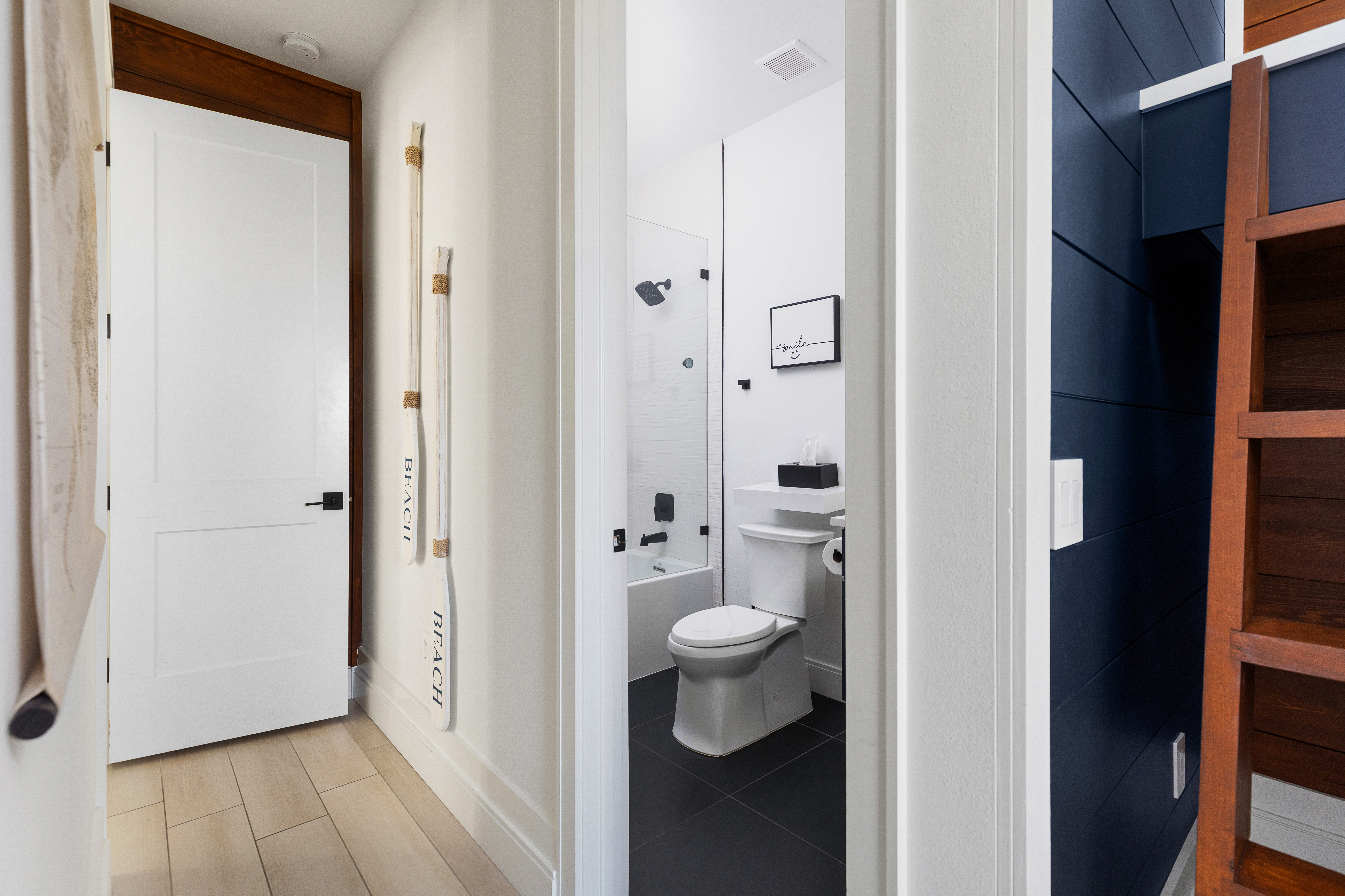 Bunk room en-suite with glass-enclosed shower and tub combo