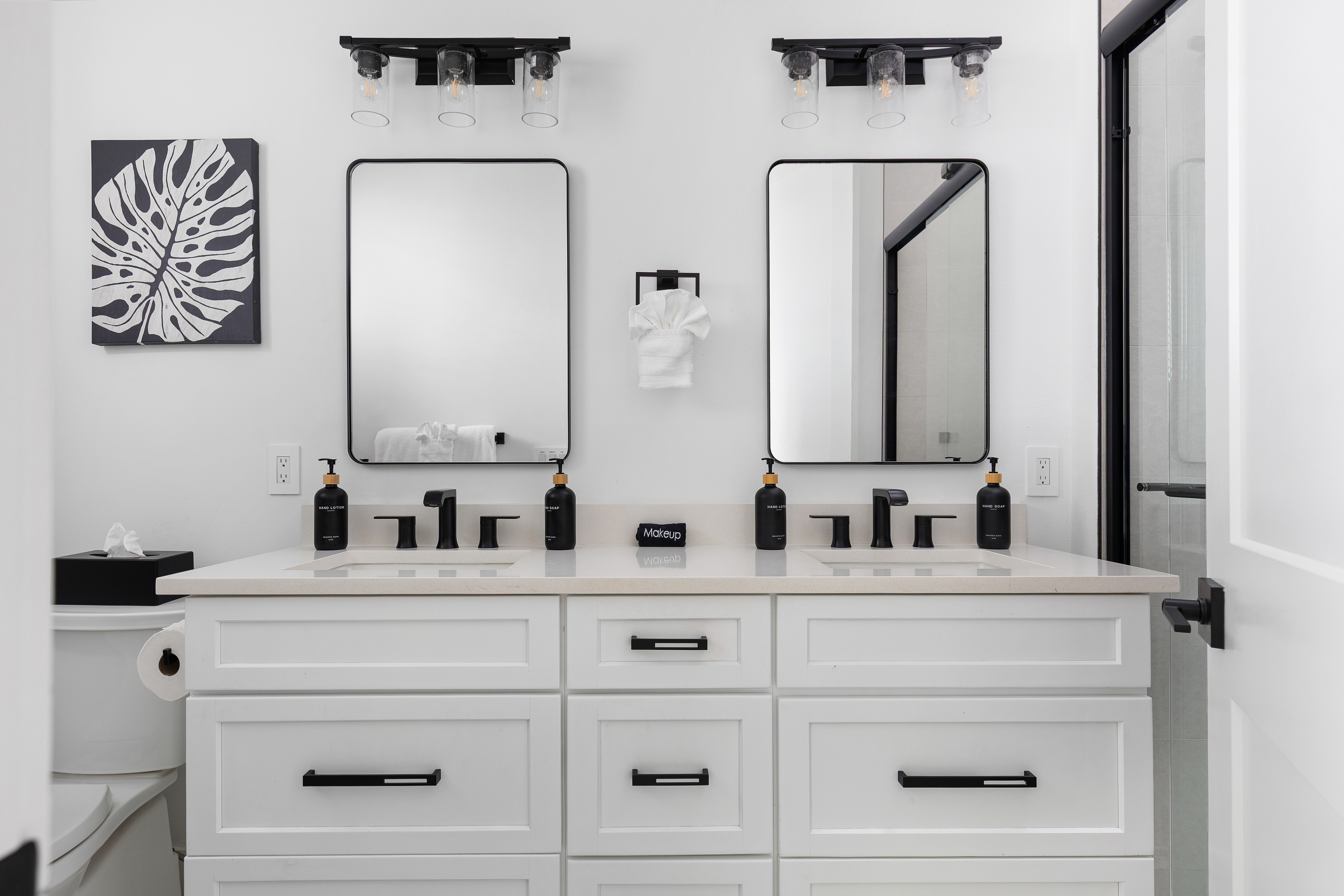 Spa-style en-suite with double vanity, matte black fixtures and walk-in shower
