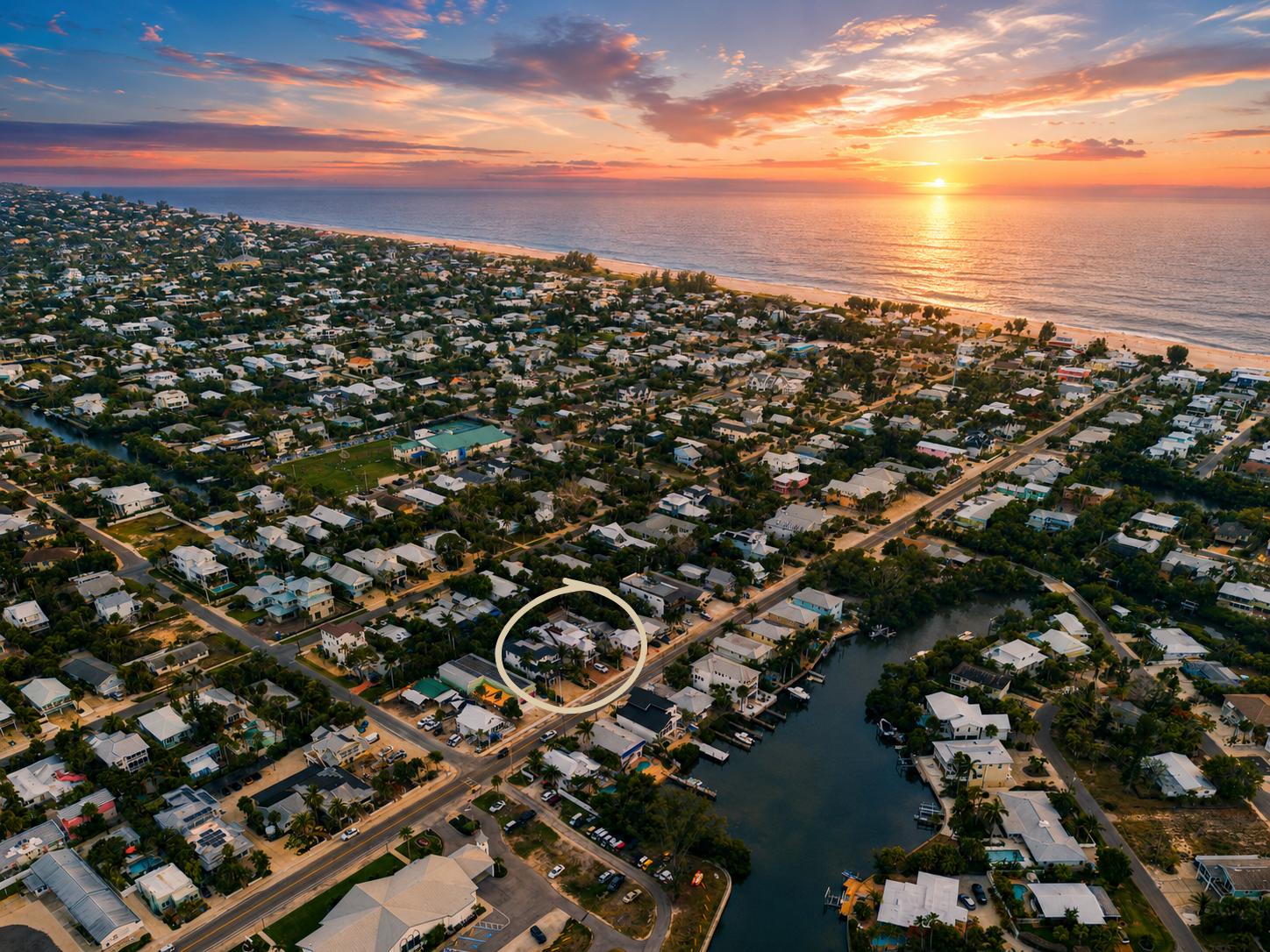 Drone sunset view of The Oar House near beach