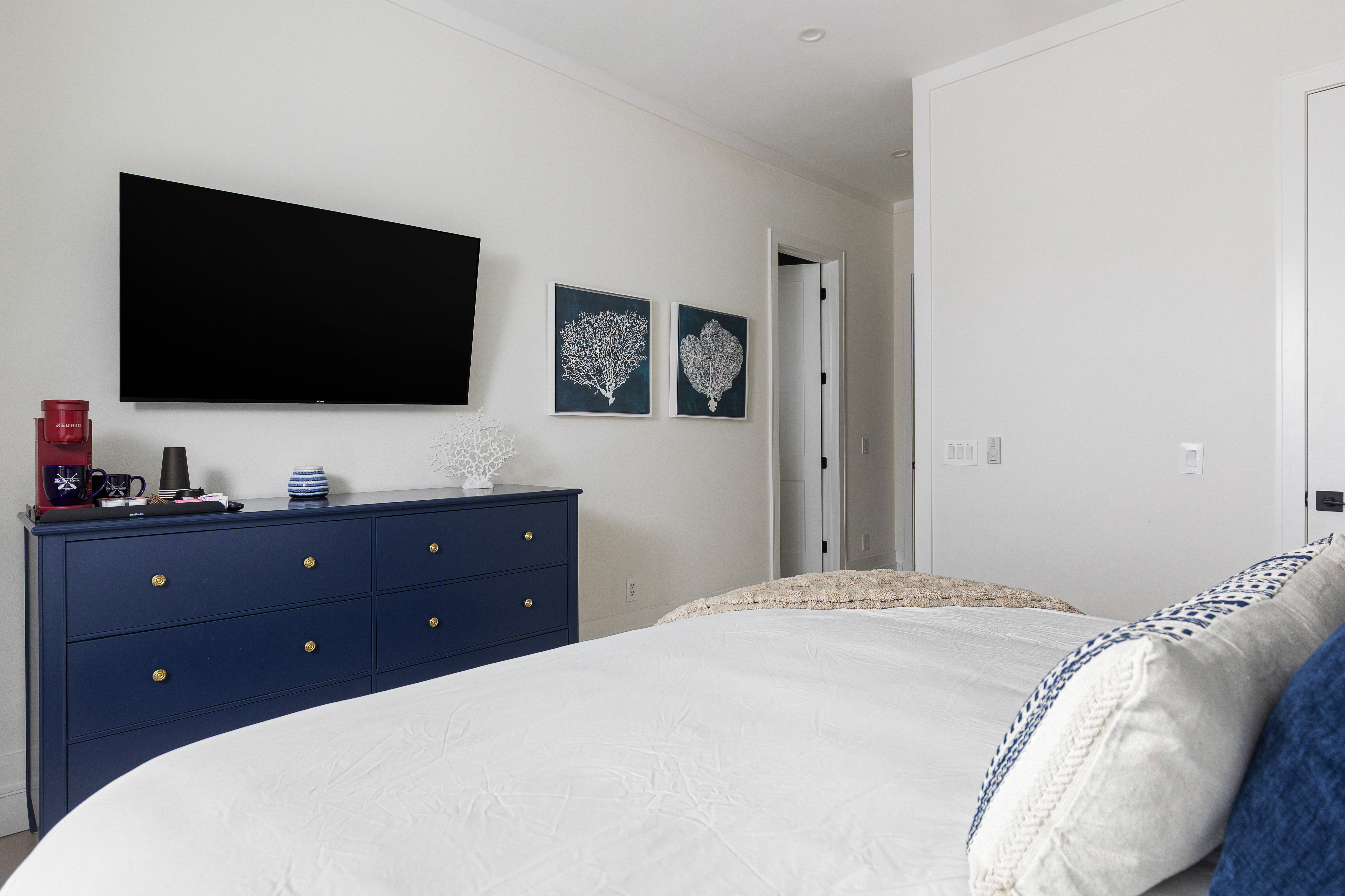 In-room coffee station with smart TV and coastal styling