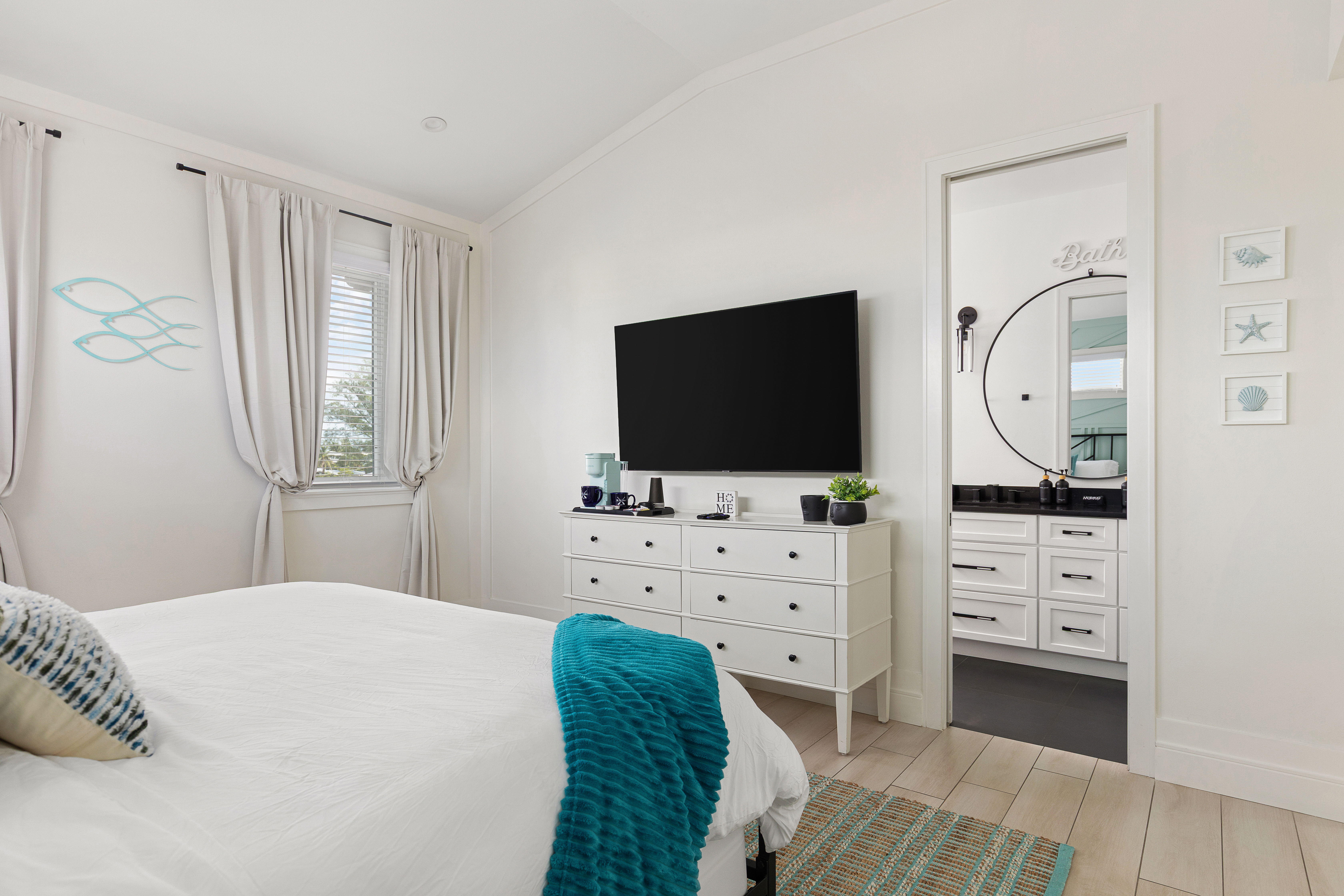 Coastal bedroom with en-suite bath and modern styling