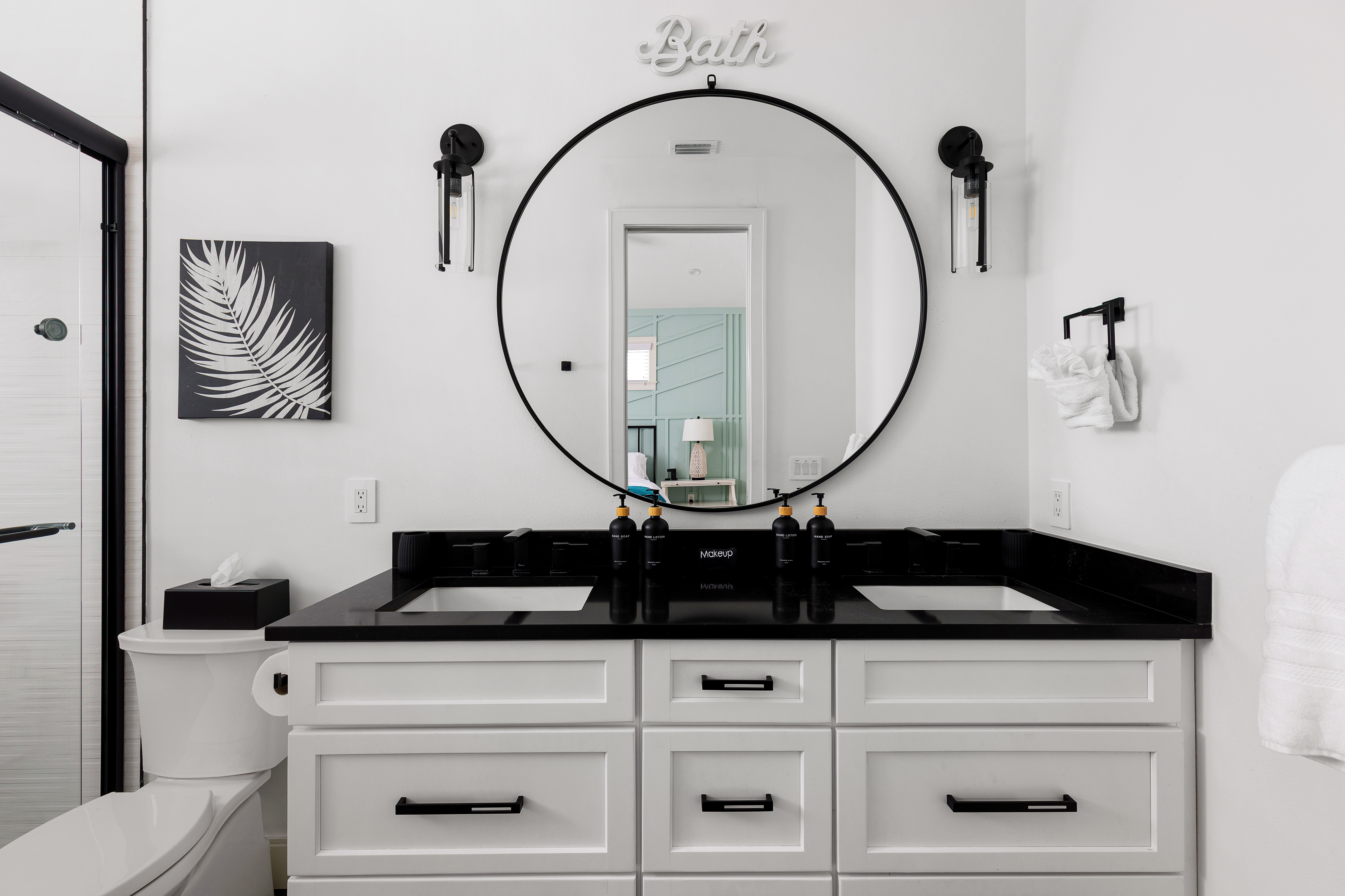 Designer bath with dual vanity and black countertops