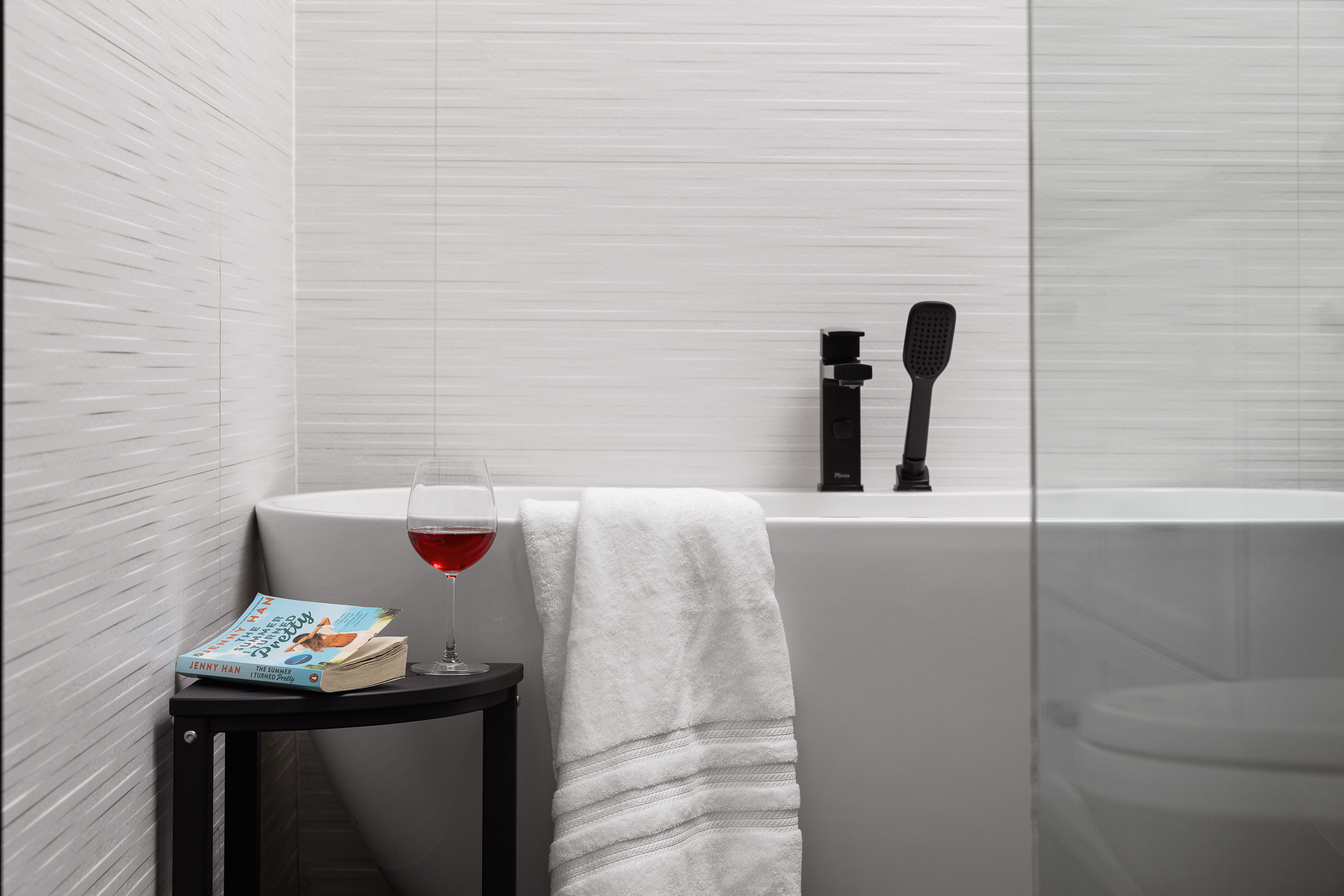 Freestanding soaking tub beside the window