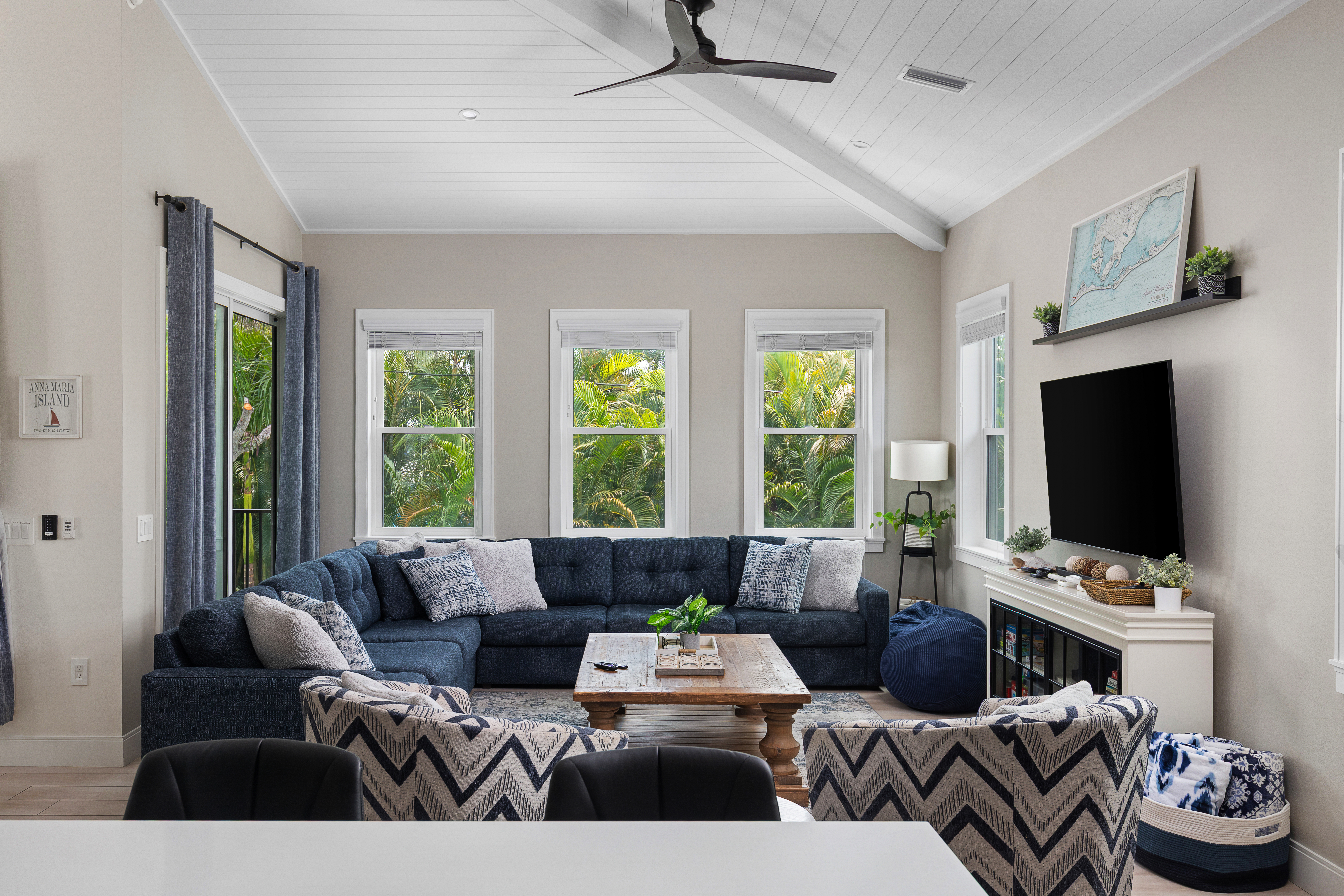 Living room with vaulted ceilings, plush sectional and Roku TV