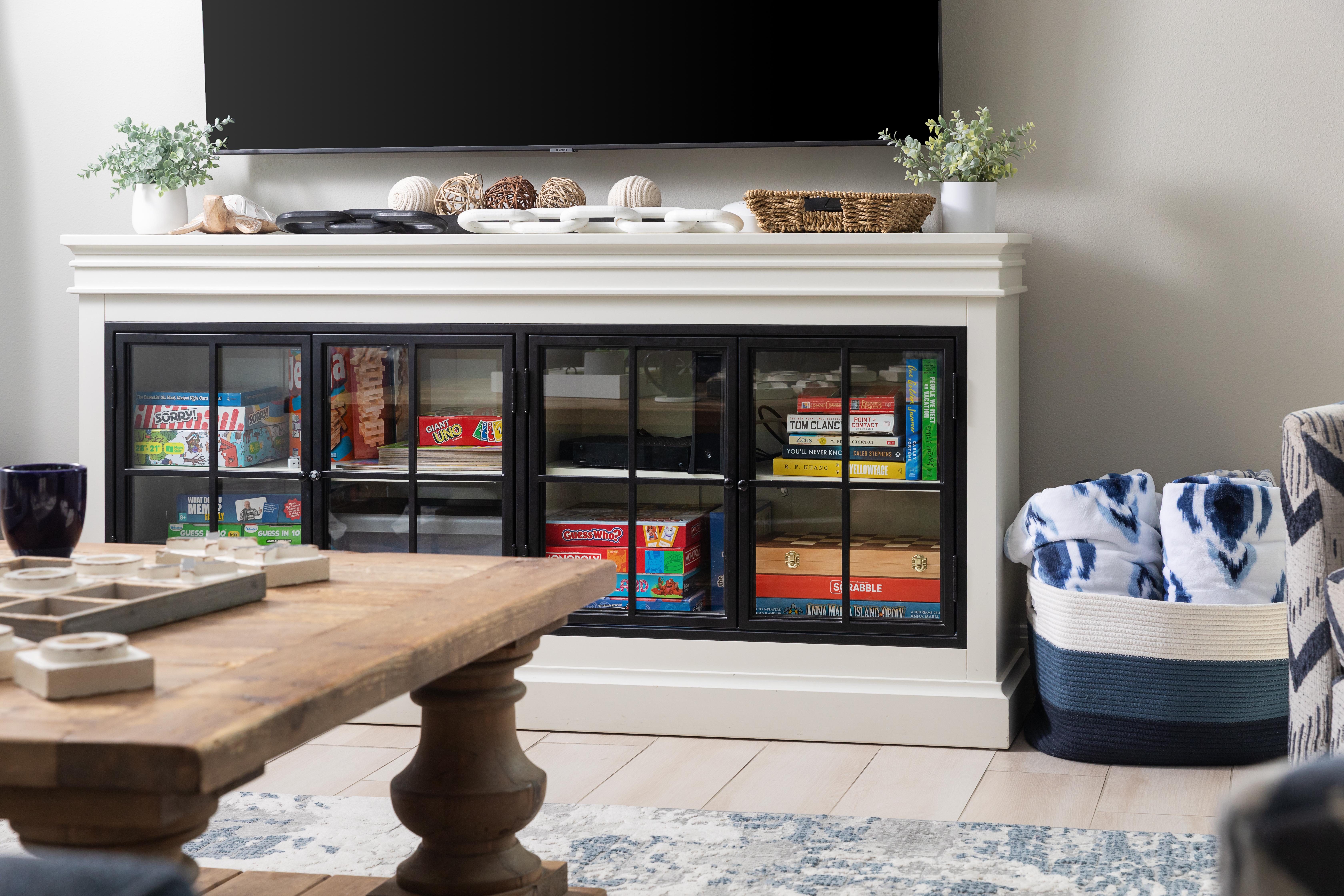 Console stocked with board games and blankets for family game night