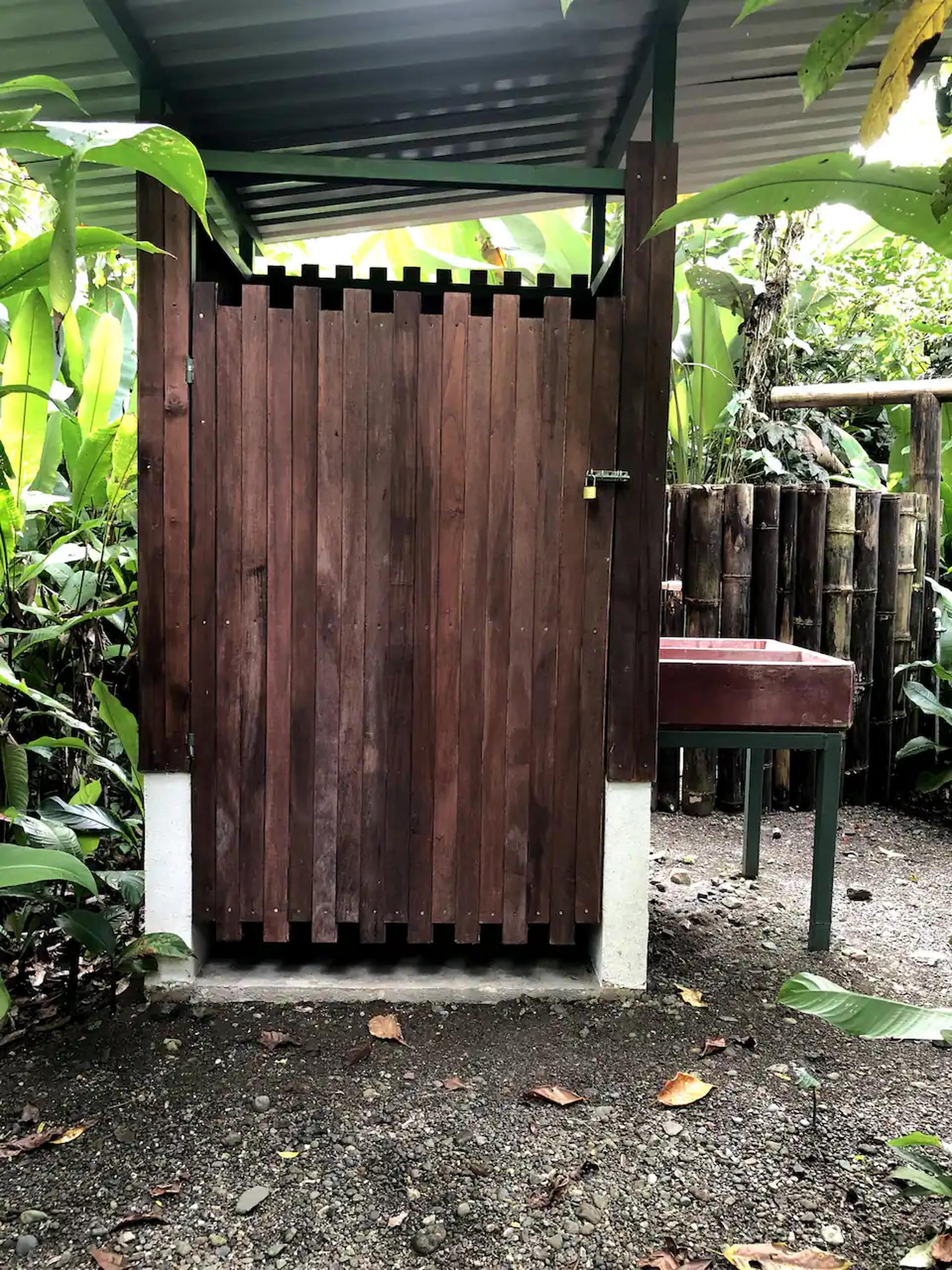 Private open-air bath surrounded by lush tropical greenery
