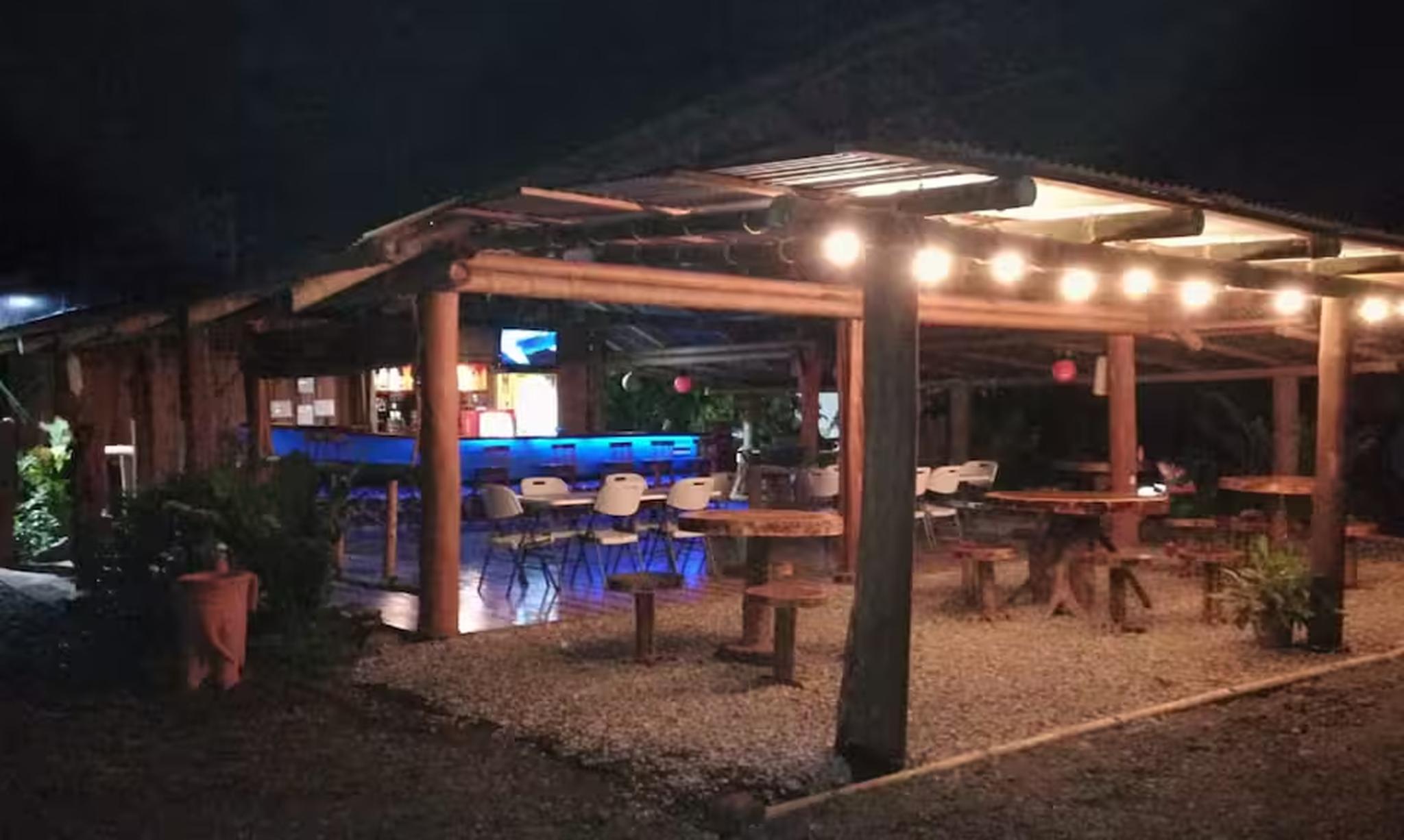 Covered outdoor bar and patio with warm lighting for relaxed evening gatherings
