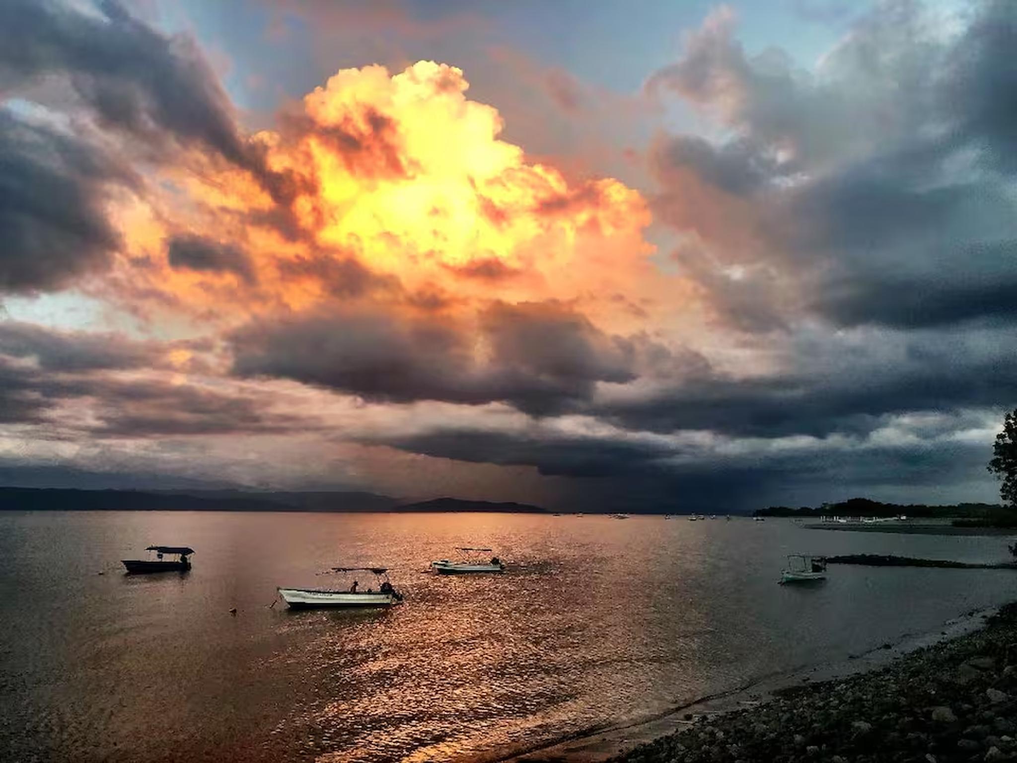 Stunning waterfront sunset views with boats and a dramatic glowing sky