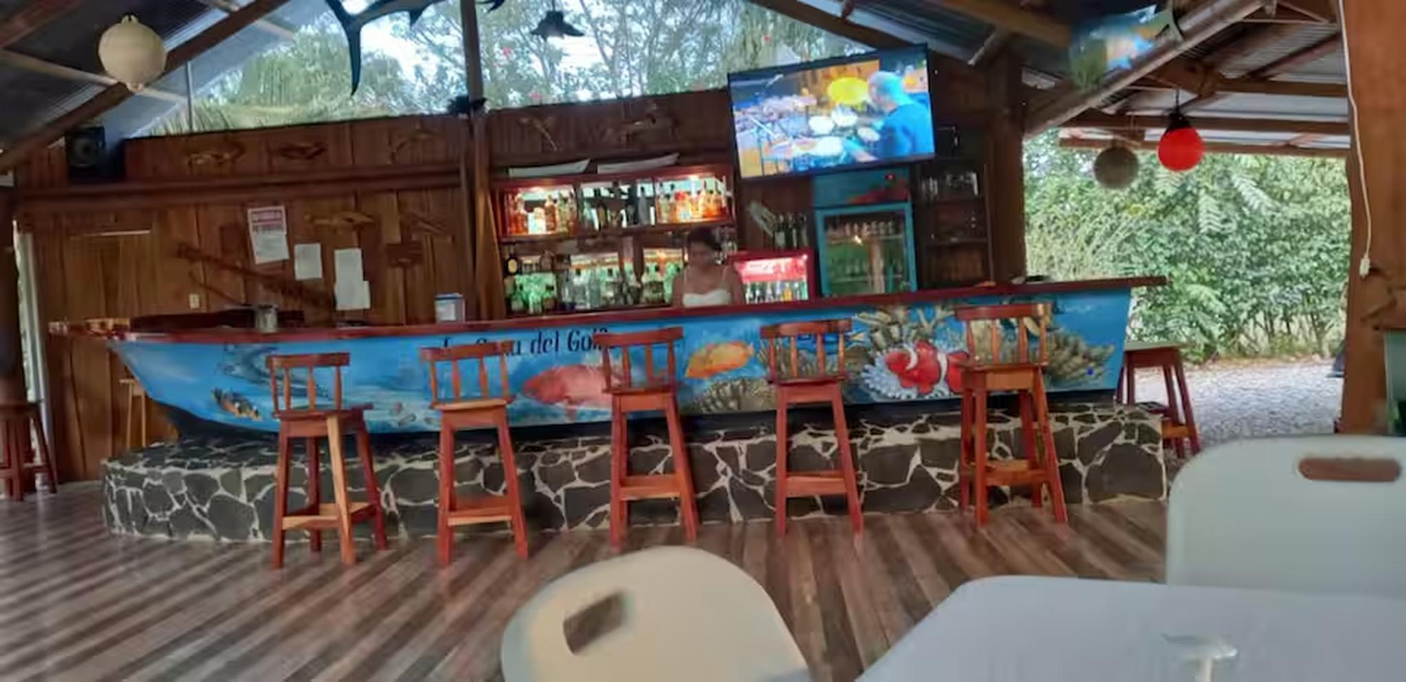 Open-air tropical bar with a unique boat bar and relaxed lounge vibe