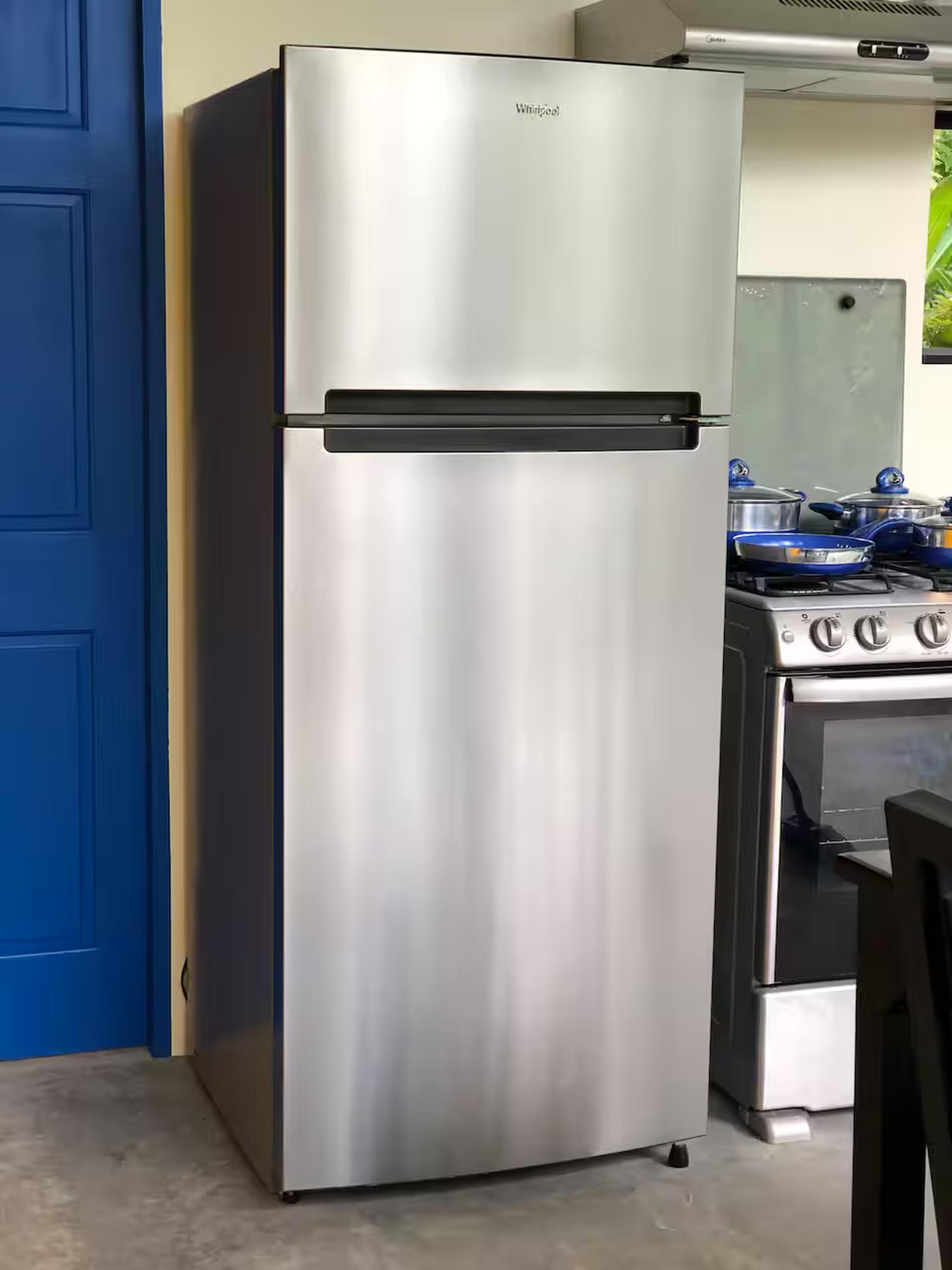 Modern stainless kitchen with full-size fridge and stove