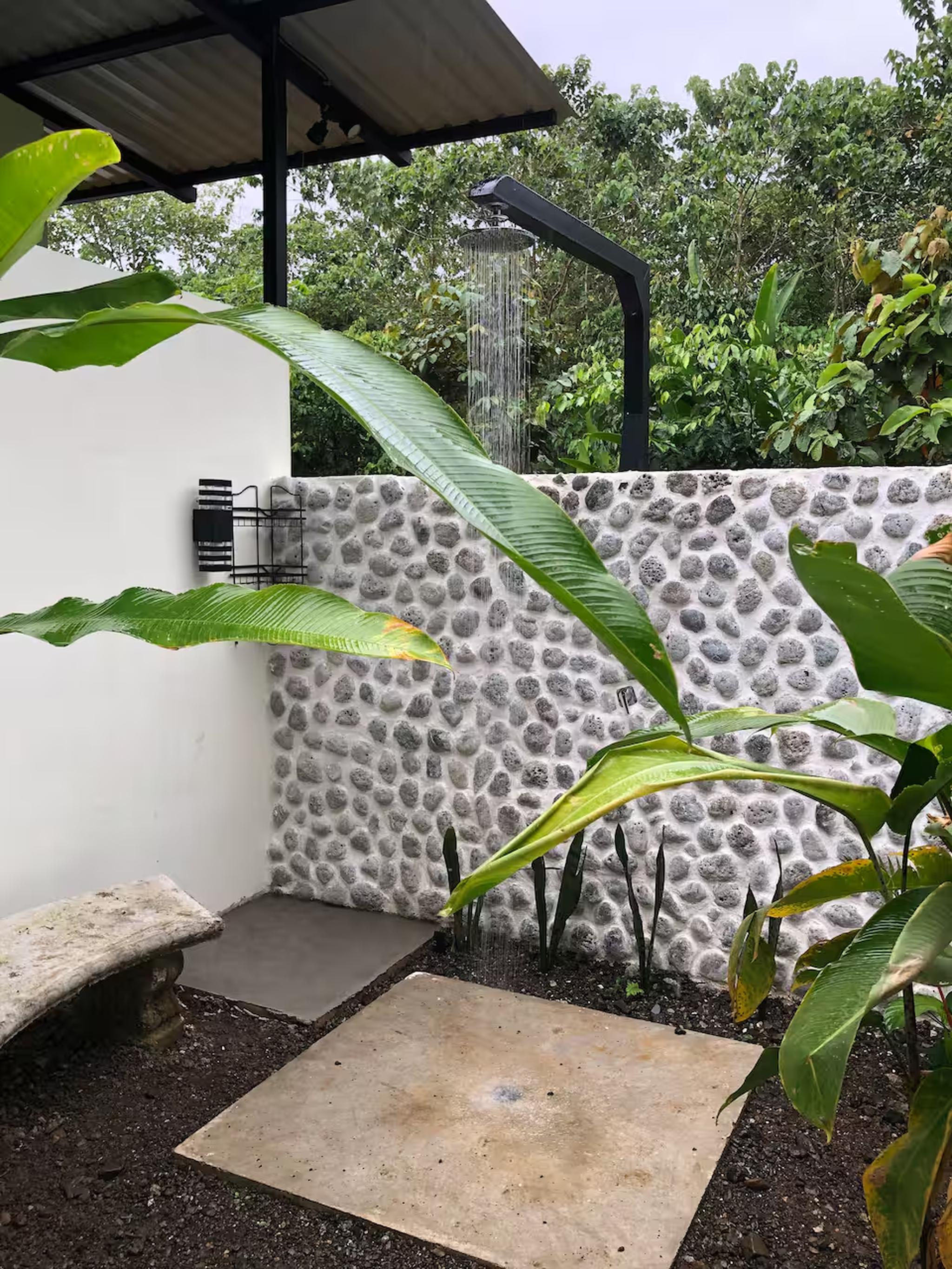 Private open-air tropical shower with spa-like garden ambiance