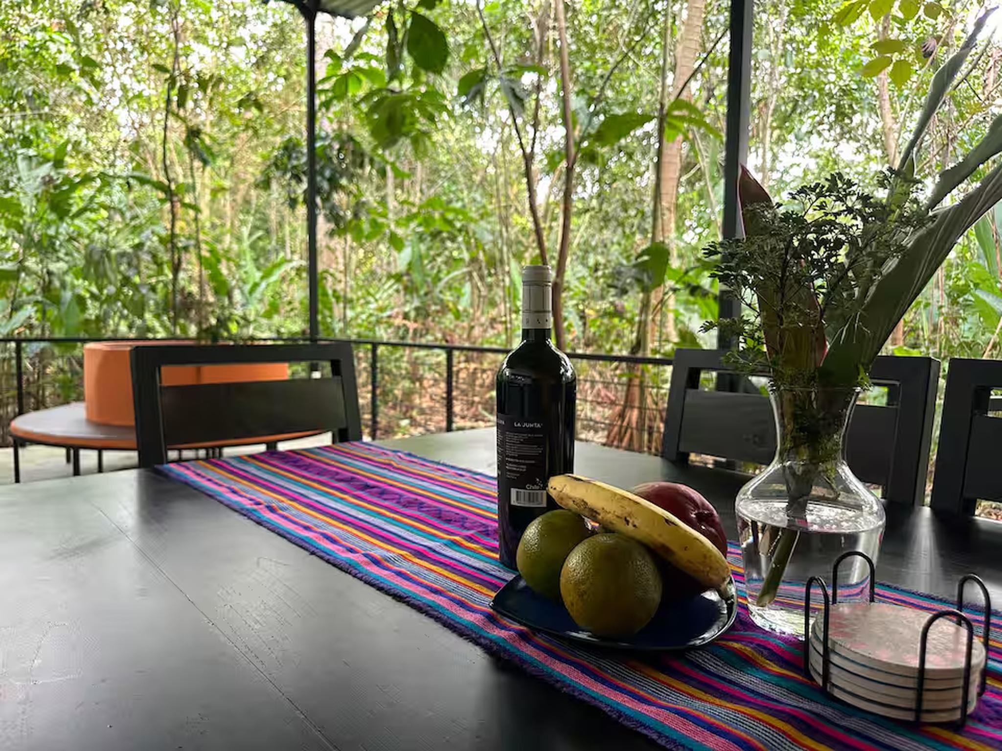 Covered jungle-view dining patio with fresh fruit and tropical ambiance