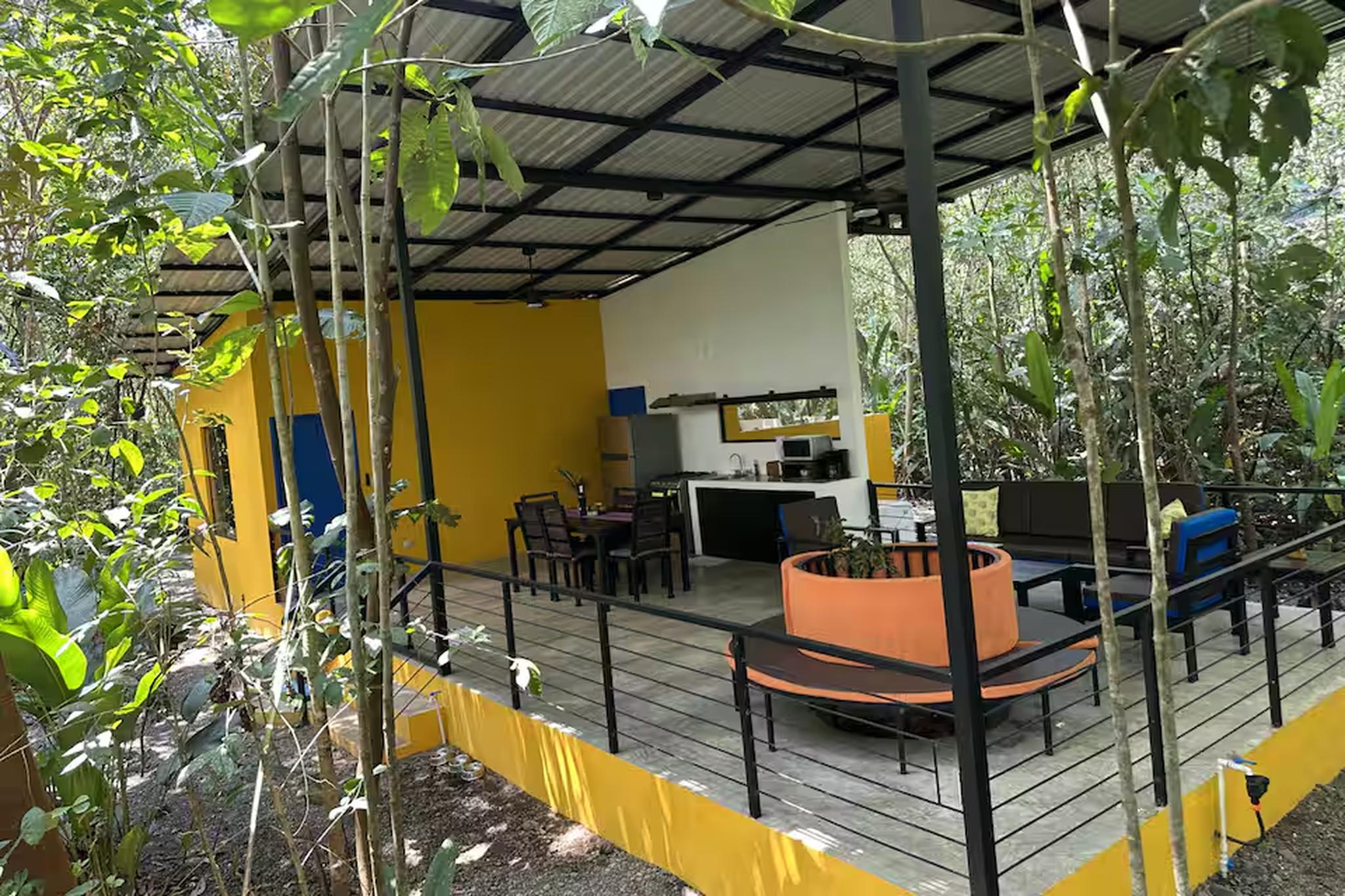 Private jungle deck with covered lounge, dining area, and outdoor kitchen