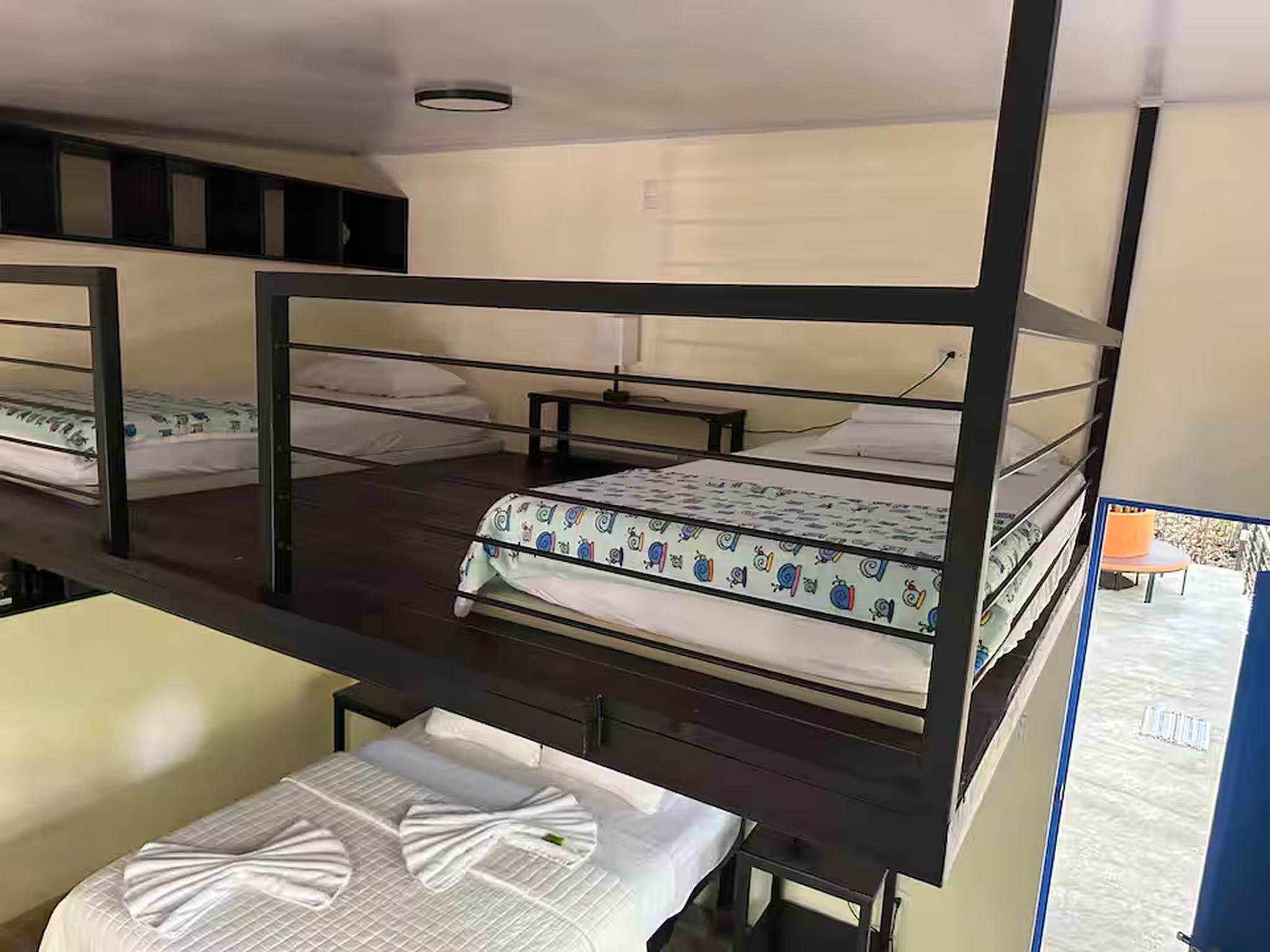 Loft-style group sleeping area with multiple beds and smart space design