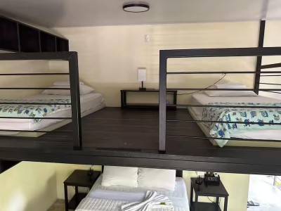 Loft-style sleeping space with multiple beds for families or groups
