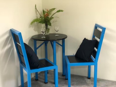 Cozy bistro nook with bright seating, fresh flowers, and wine glasses