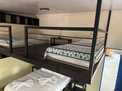 Loft-style group sleeping area with multiple beds and smart space design