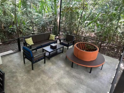 Private tropical patio with stylish lounge seating and lush jungle views