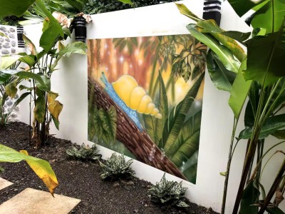 Lush tropical garden path with vibrant mural and serene resort-style charm