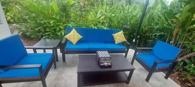Private tropical patio with cozy seating and lush garden views