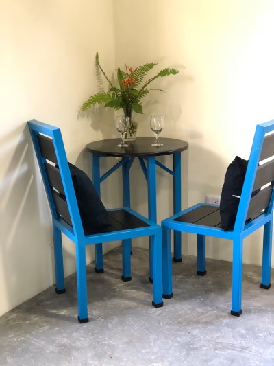 Cozy bistro-style dining nook with bold chairs and tropical accents