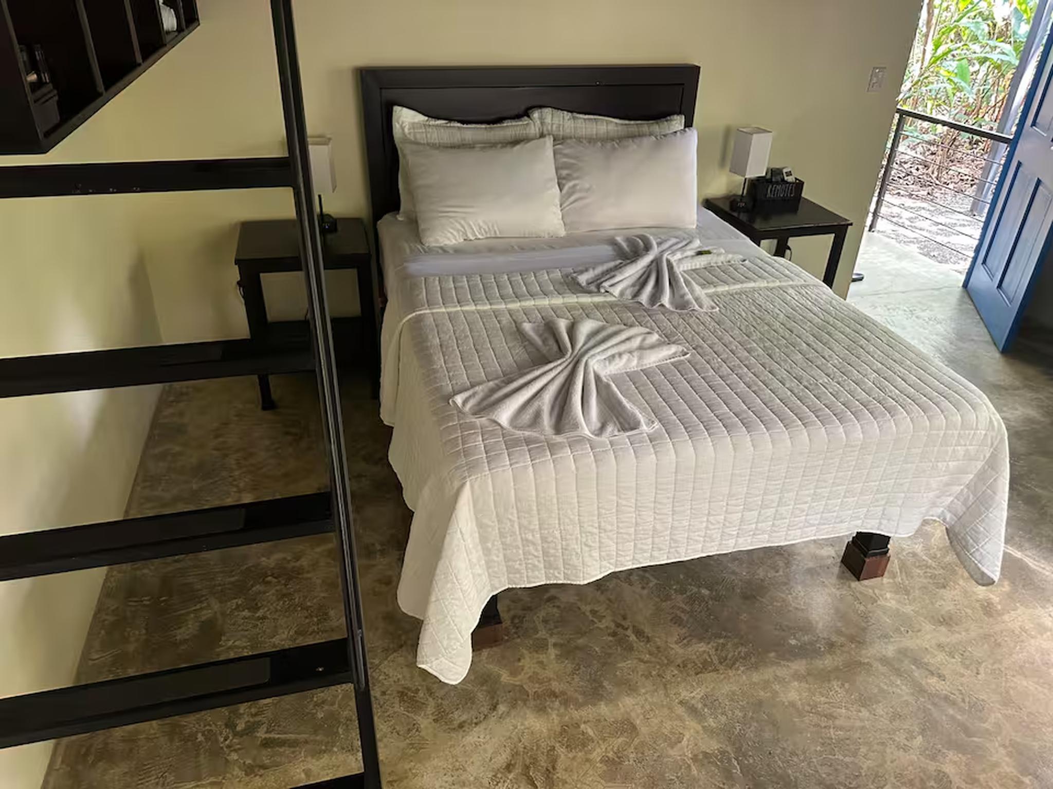 Bright, cozy bedroom with crisp linens and easy outdoor access