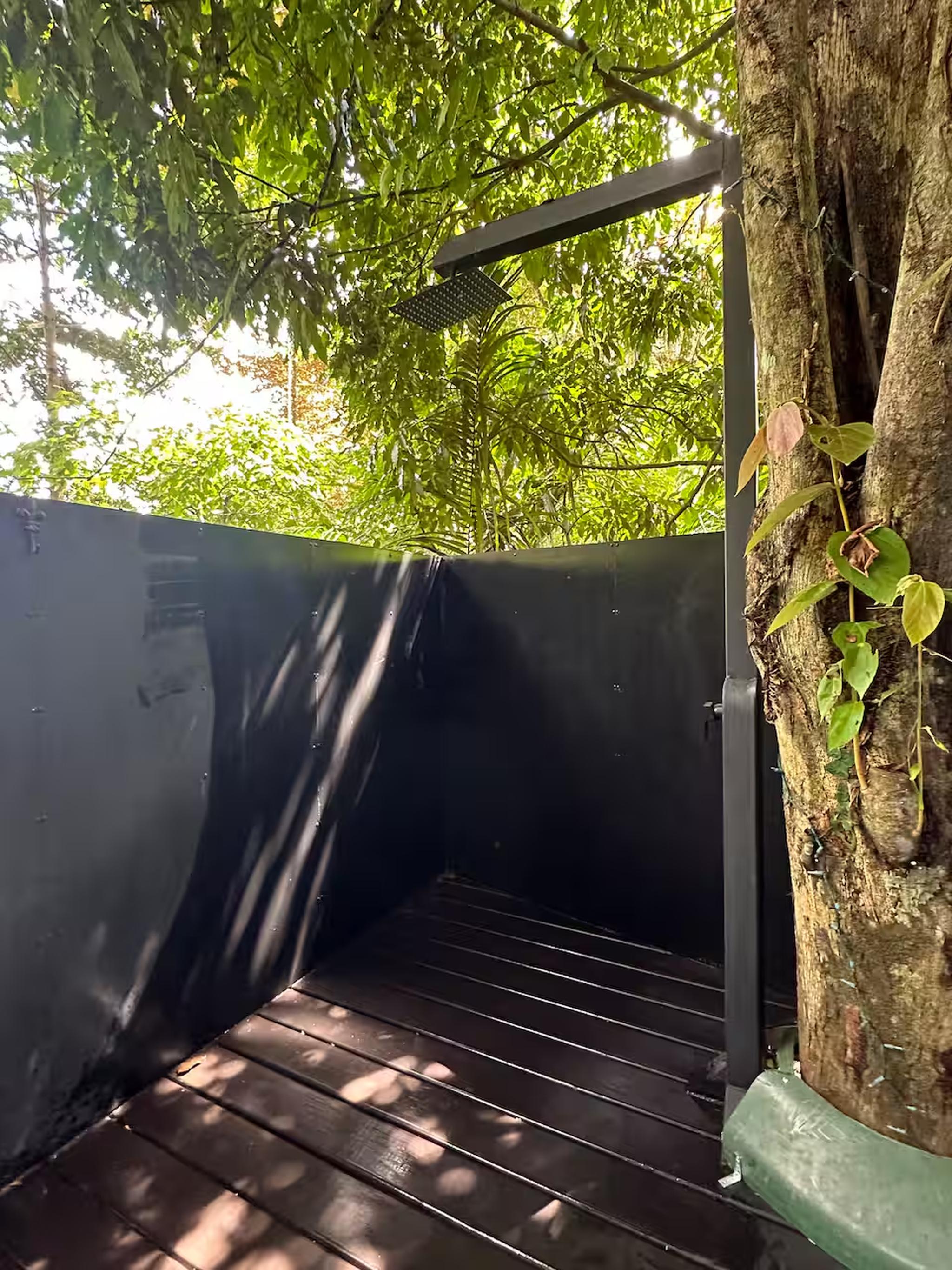 Private open-air rainforest shower with peaceful tropical surroundings