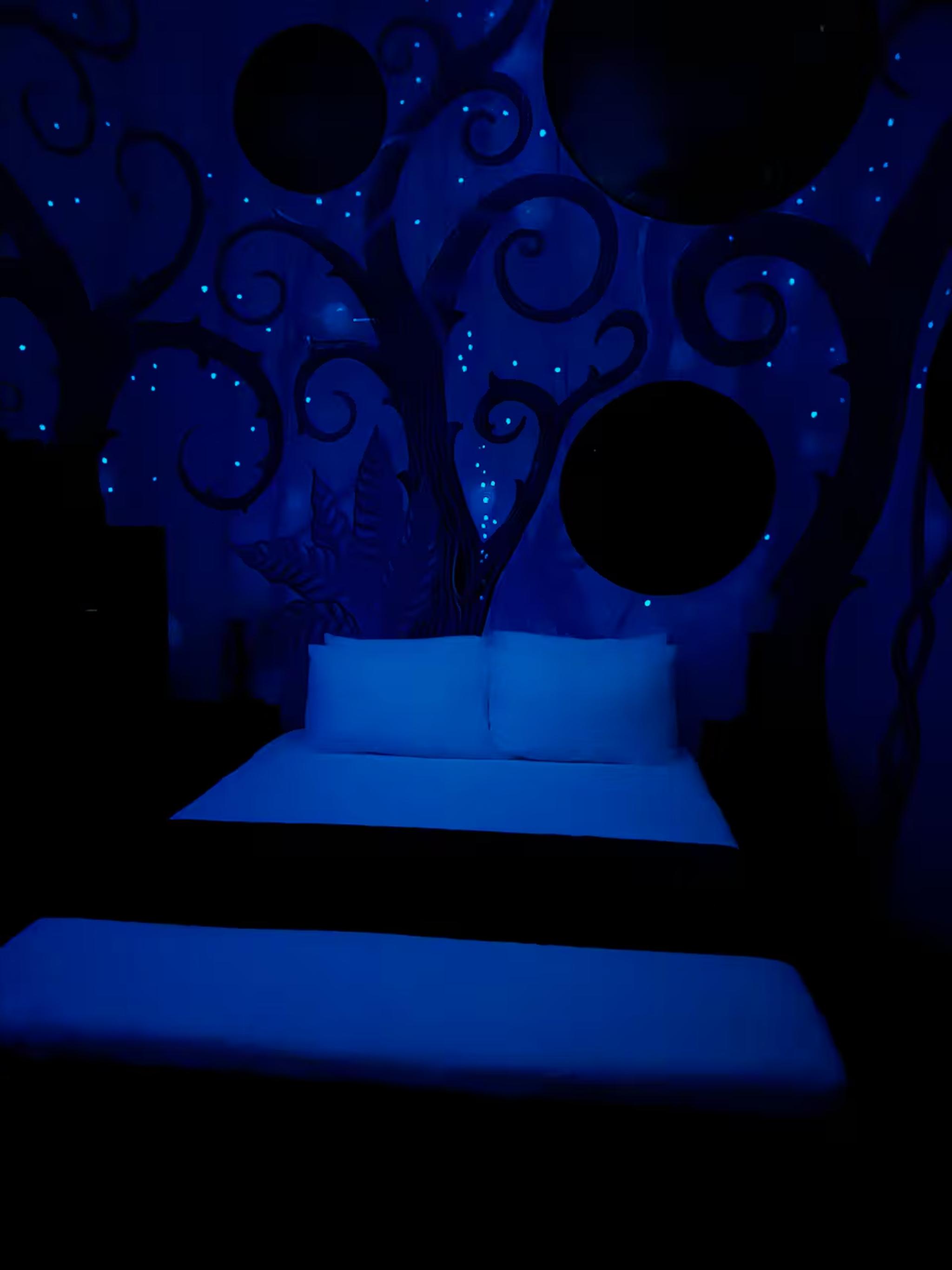 Whimsical glow-in-the-dark bedroom with dreamy, immersive ambiance