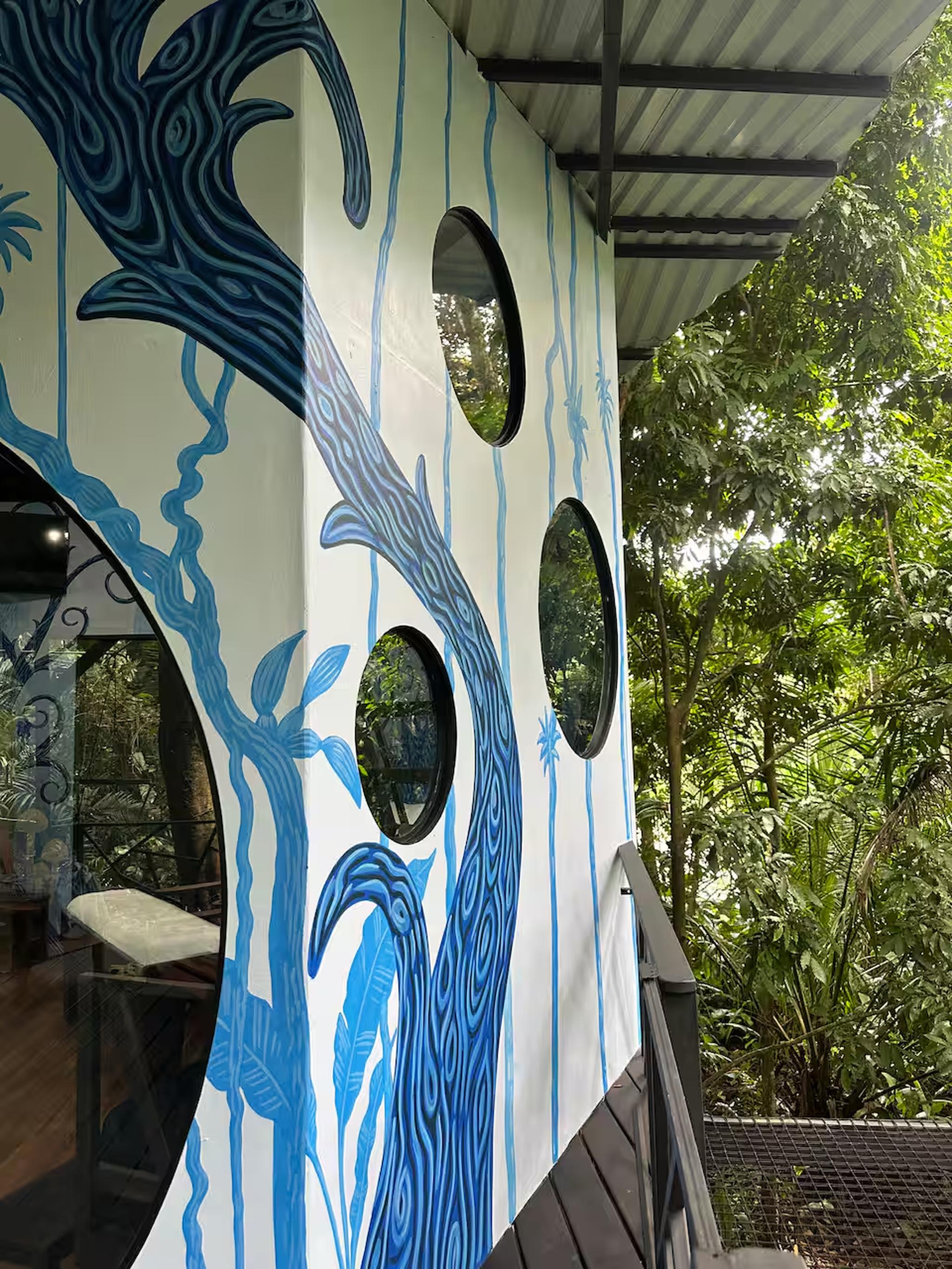 Artful jungle hideaway with porthole windows and tropical views